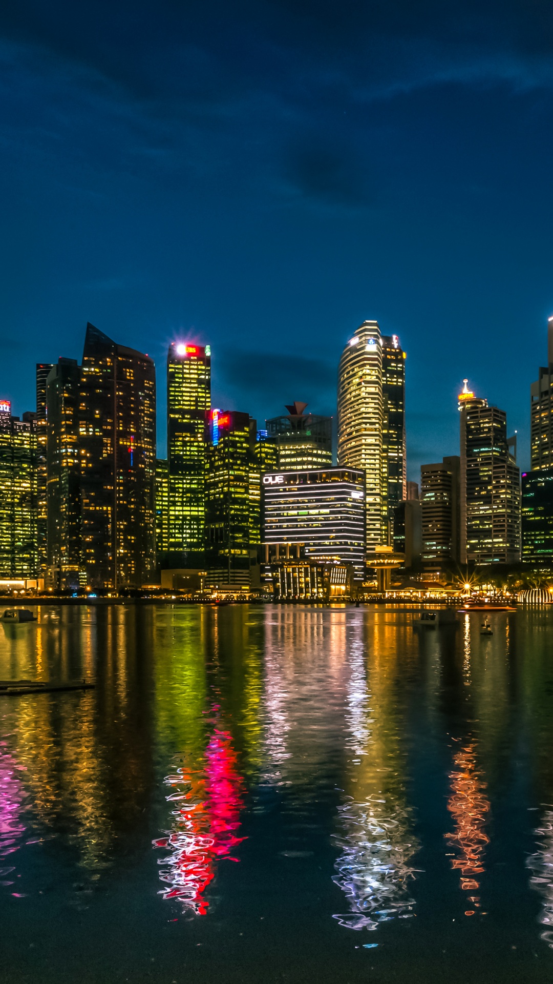 City Skyline Across Body of Water During Night Time. Wallpaper in 1080x1920 Resolution