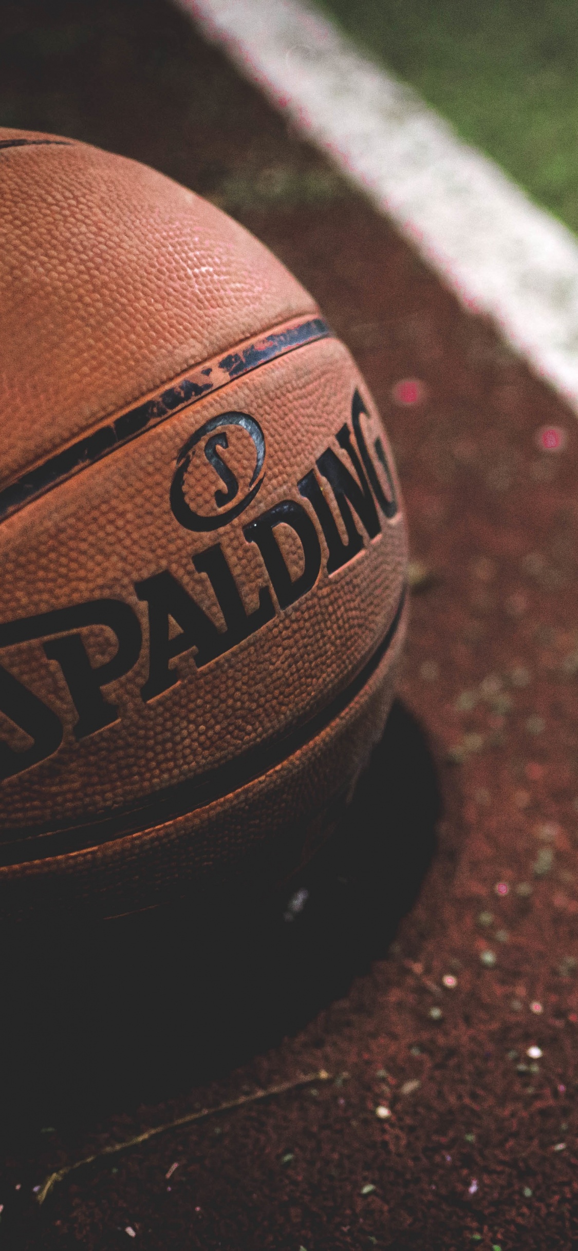 Brown and Black Basketball on Brown and White Concrete Floor. Wallpaper in 1125x2436 Resolution