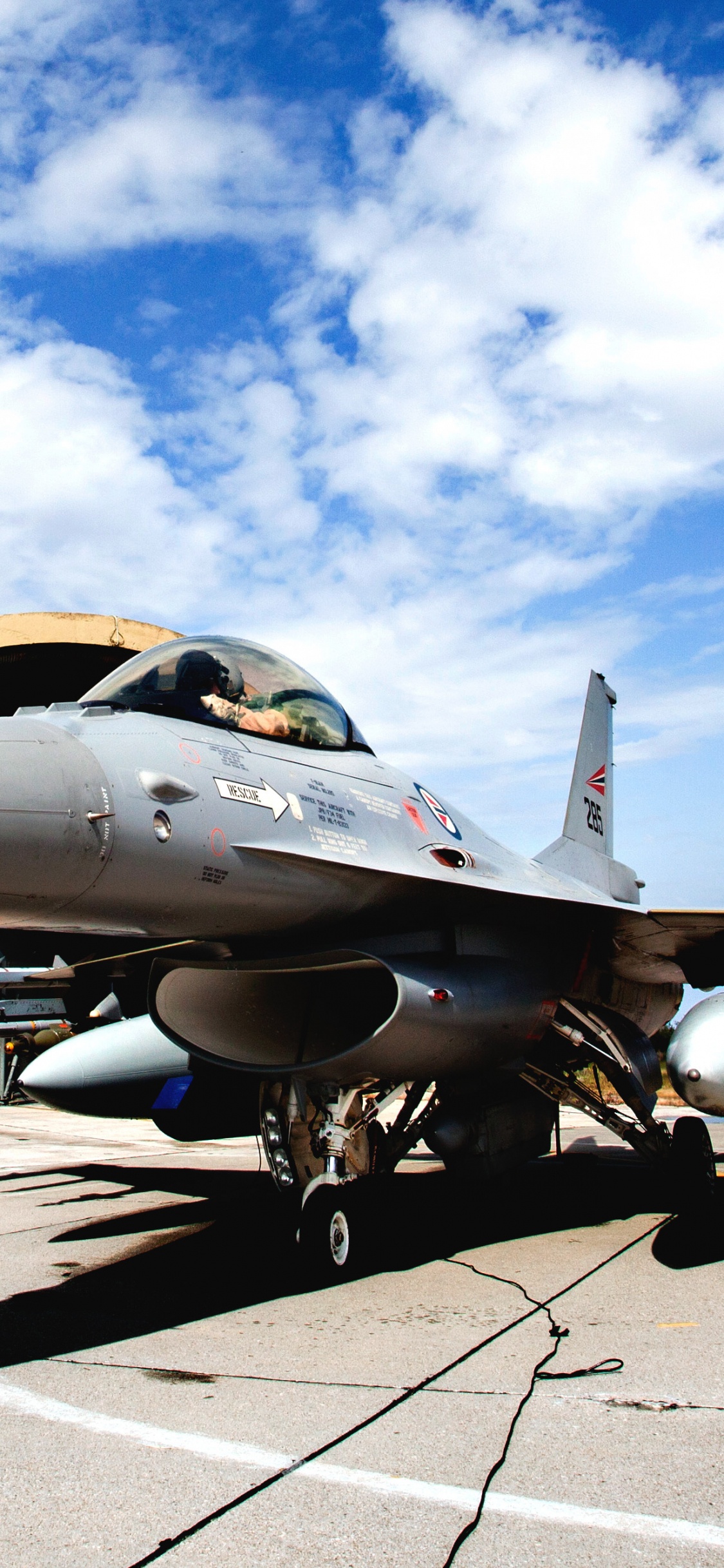 Gray Fighter Jet on Gray Concrete Ground Under Blue and White Sunny Cloudy Sky During Daytime. Wallpaper in 1125x2436 Resolution
