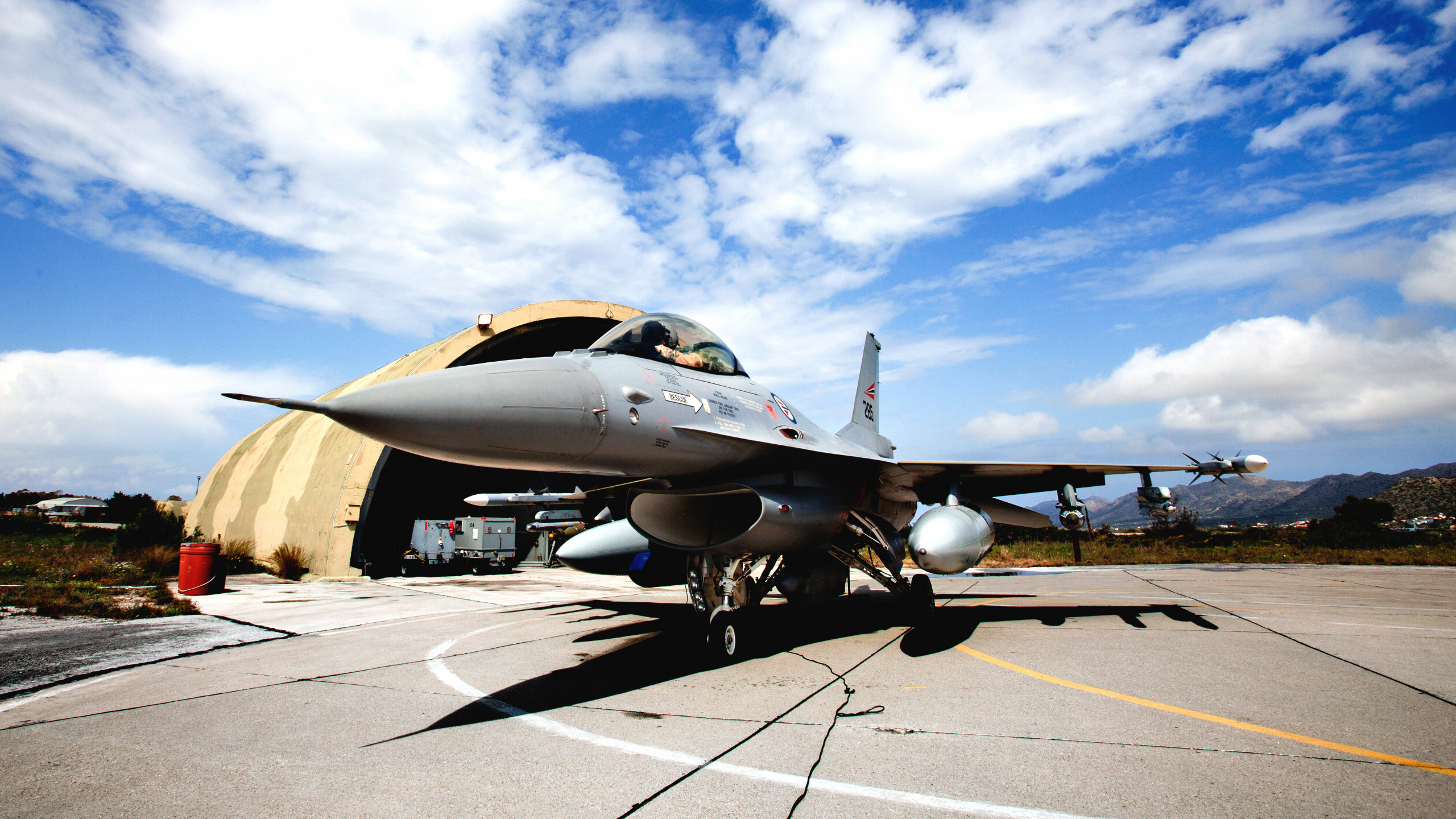 Gray Fighter Jet on Gray Concrete Ground Under Blue and White Sunny Cloudy Sky During Daytime. Wallpaper in 2560x1440 Resolution