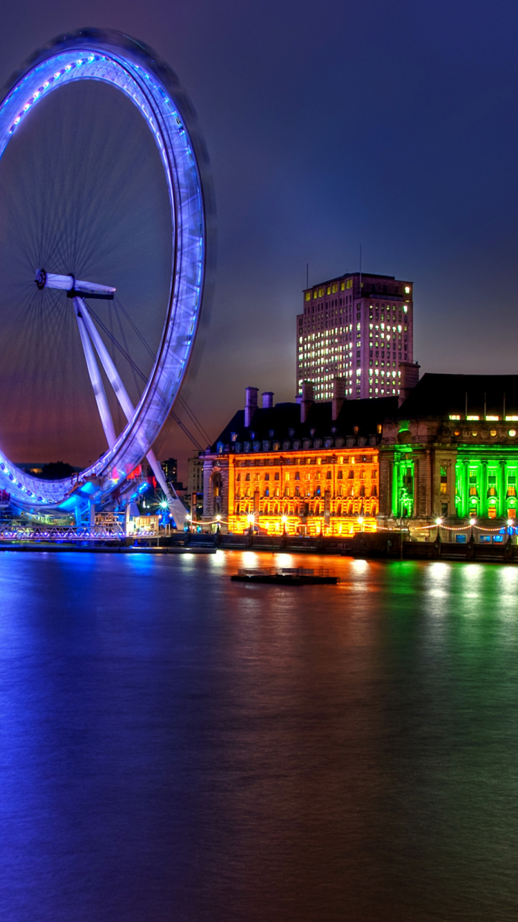 Grande Roue Près Des Bâtiments de la Ville Pendant la Nuit. Wallpaper in 750x1334 Resolution