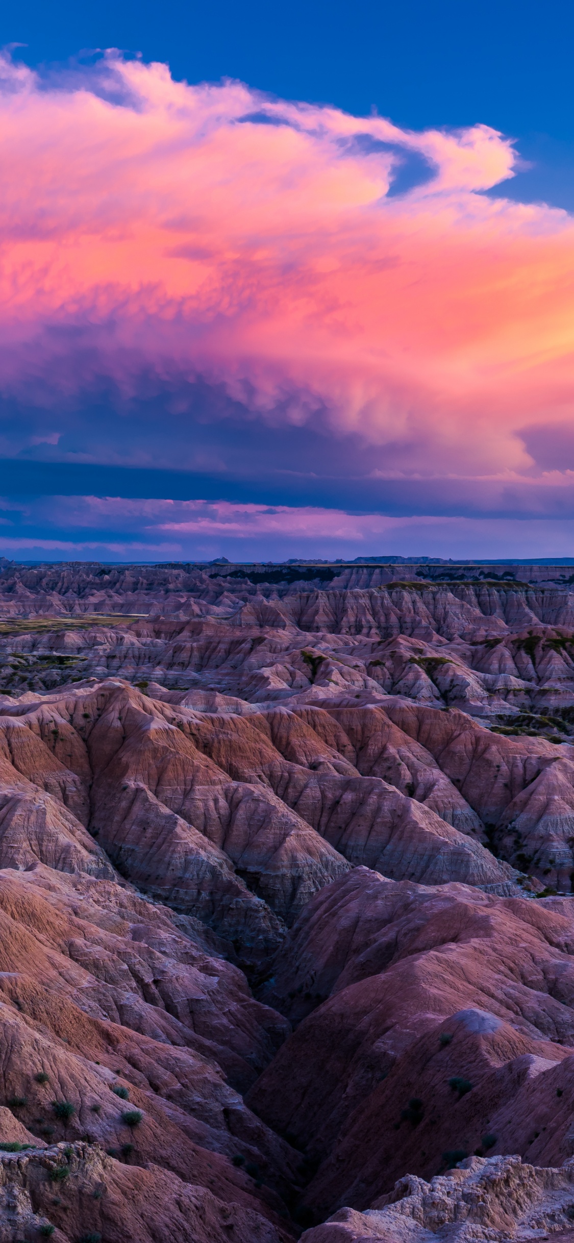 Brown Rocky Mountain Under Blue Sky. Wallpaper in 1125x2436 Resolution