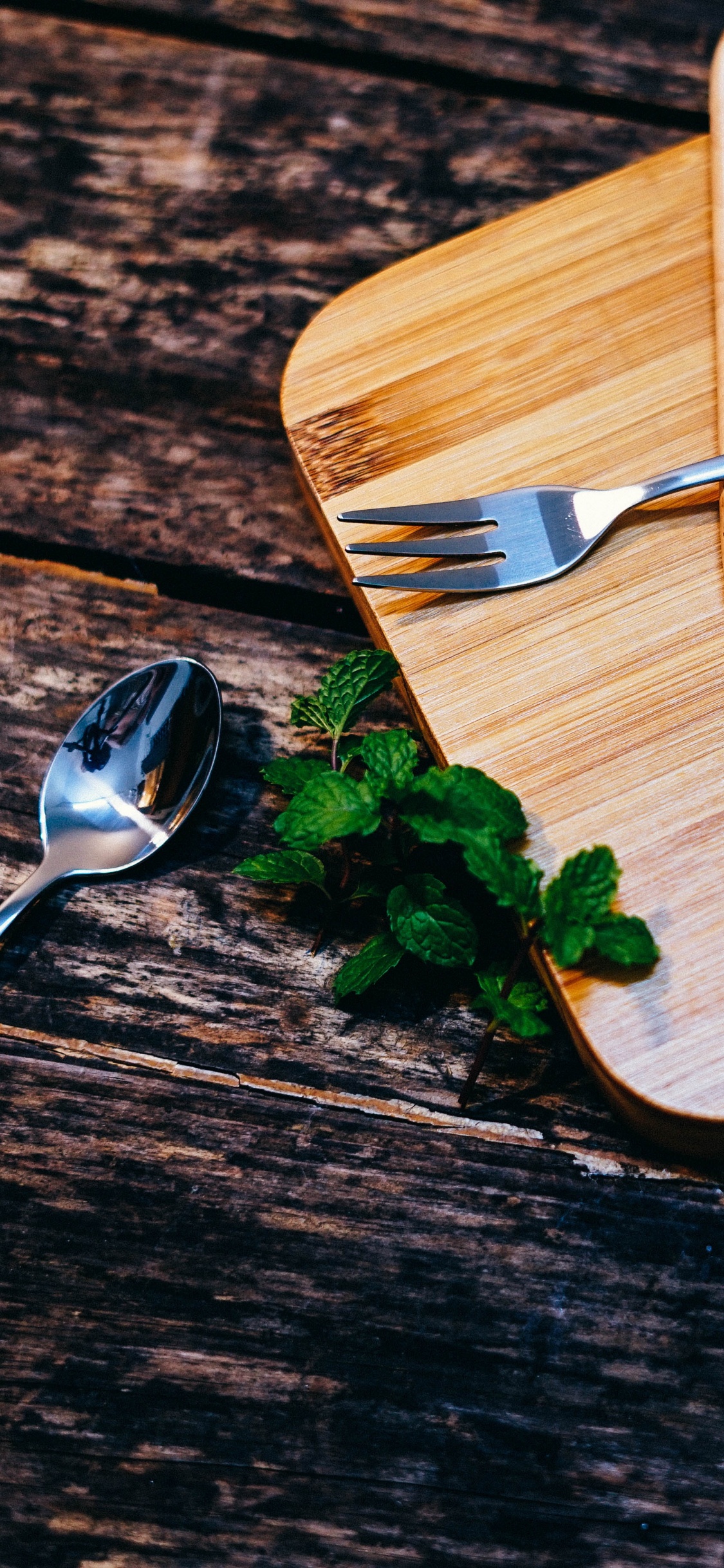 Stainless Steel Fork on Brown Wooden Chopping Board. Wallpaper in 1125x2436 Resolution