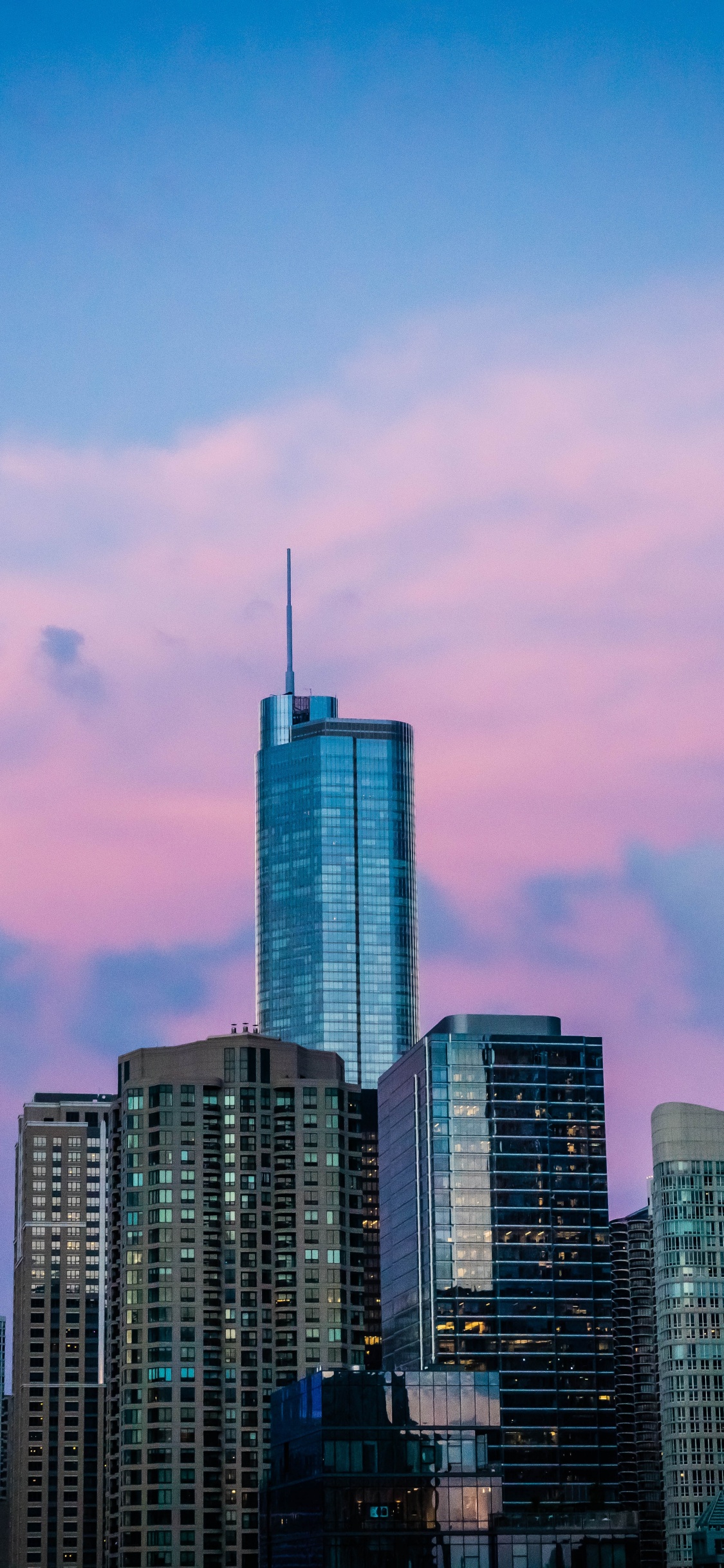 High Rise Buildings Under Blue Sky During Daytime. Wallpaper in 1125x2436 Resolution