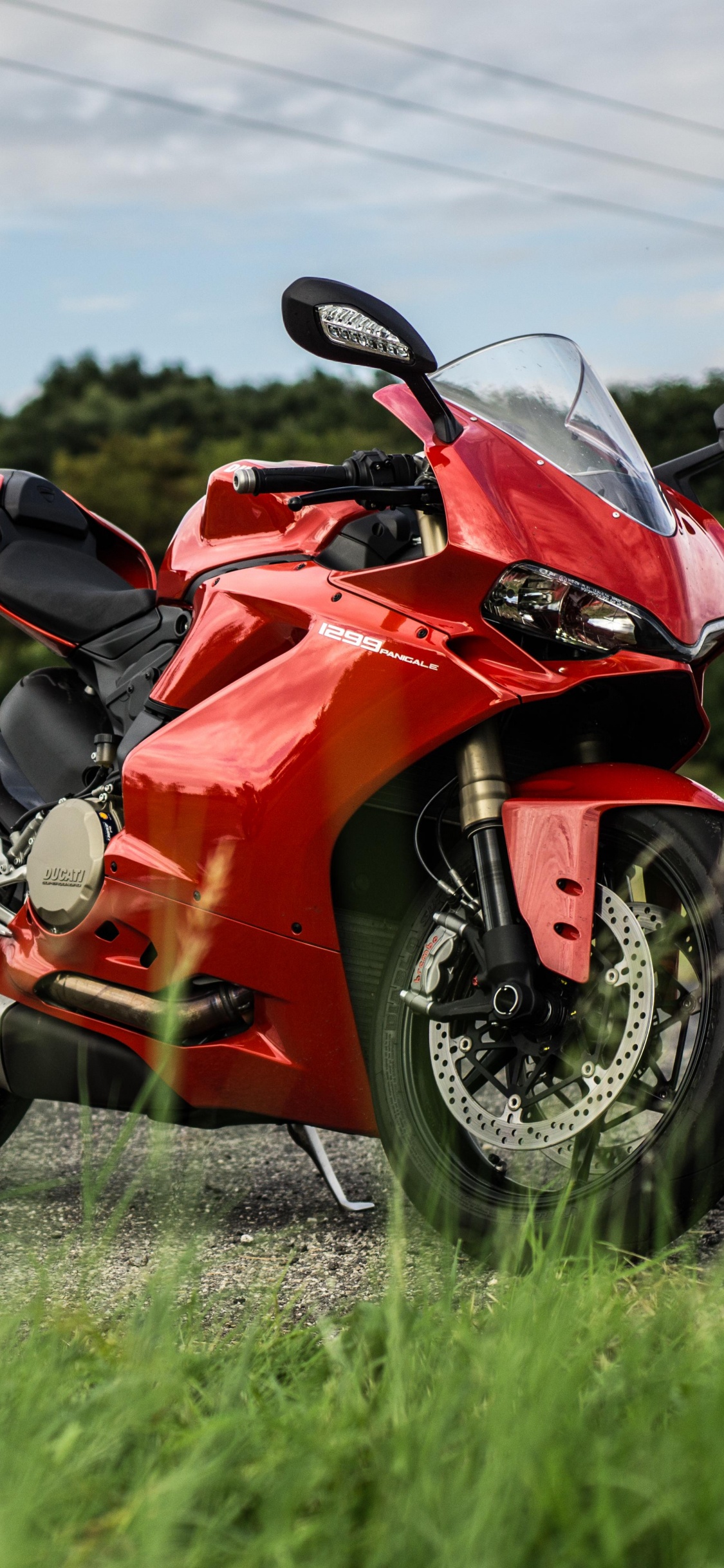 Red and Black Sports Bike on Road During Daytime. Wallpaper in 1125x2436 Resolution