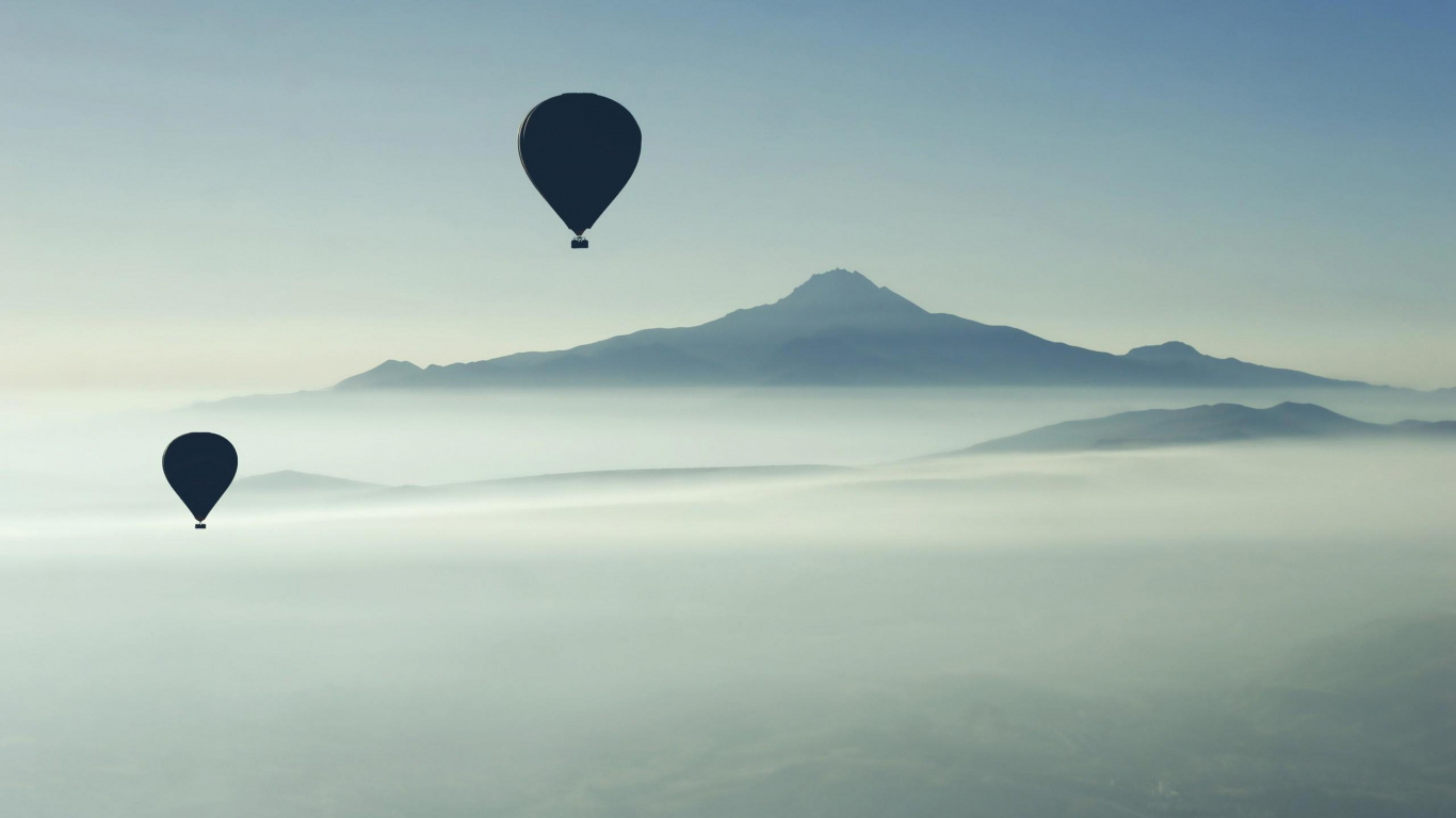 Globo Aerostático Azul Volando Sobre Las Montañas Durante el Día. Wallpaper in 1366x768 Resolution