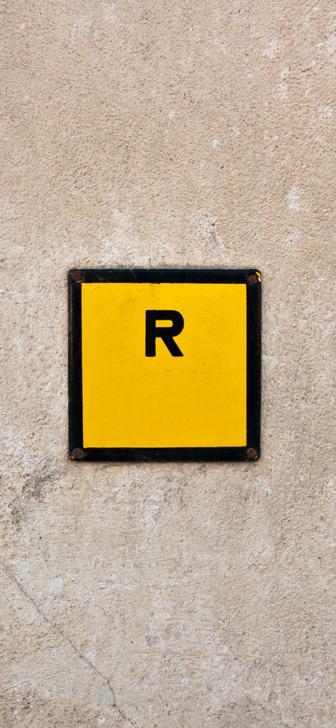 Yellow and Black 2 Print on Gray Concrete Wall. Wallpaper in 1125x2436 Resolution