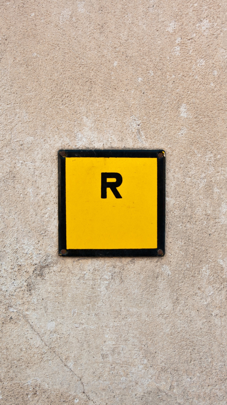 Yellow and Black 2 Print on Gray Concrete Wall. Wallpaper in 750x1334 Resolution