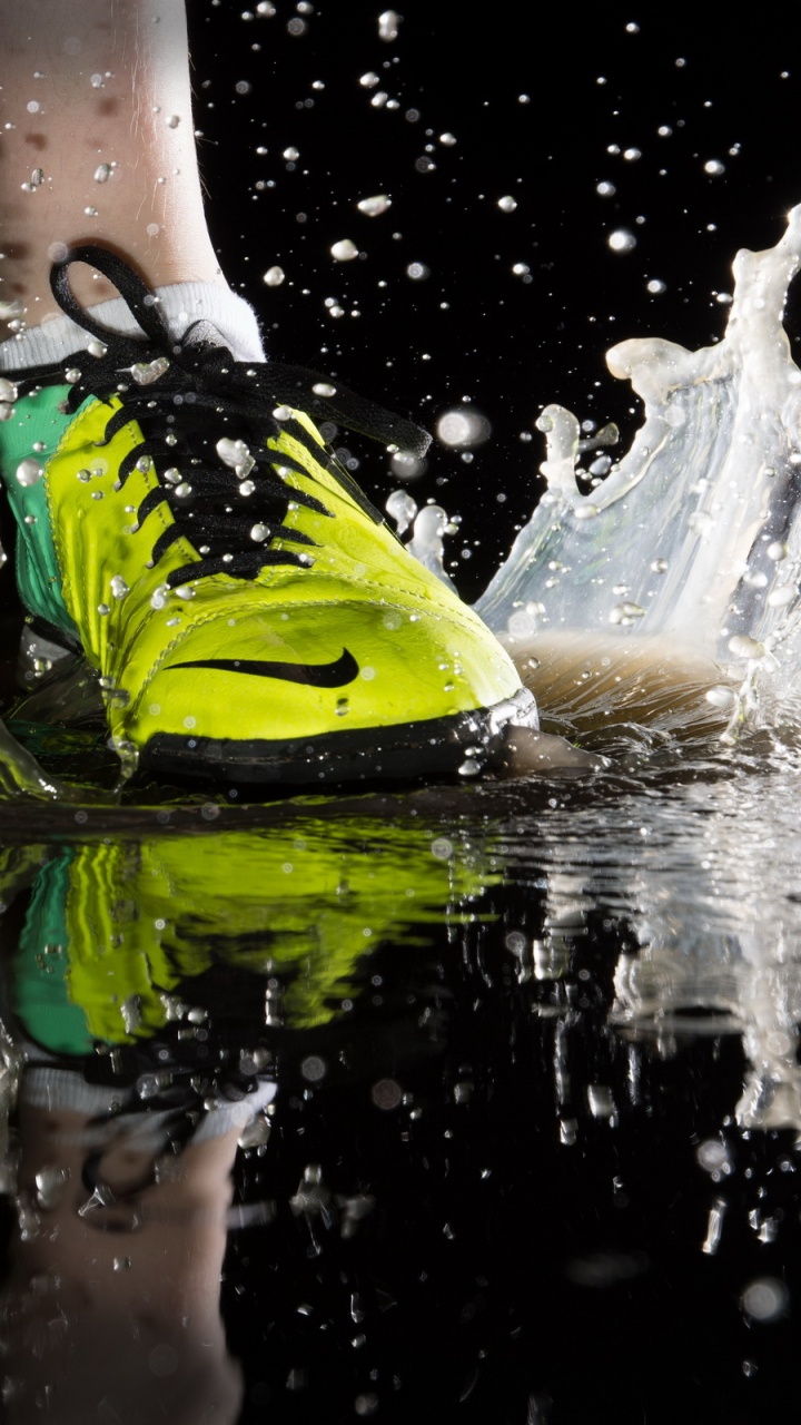 Person in Green and Black Nike Athletic Shoes on Water. Wallpaper in 720x1280 Resolution