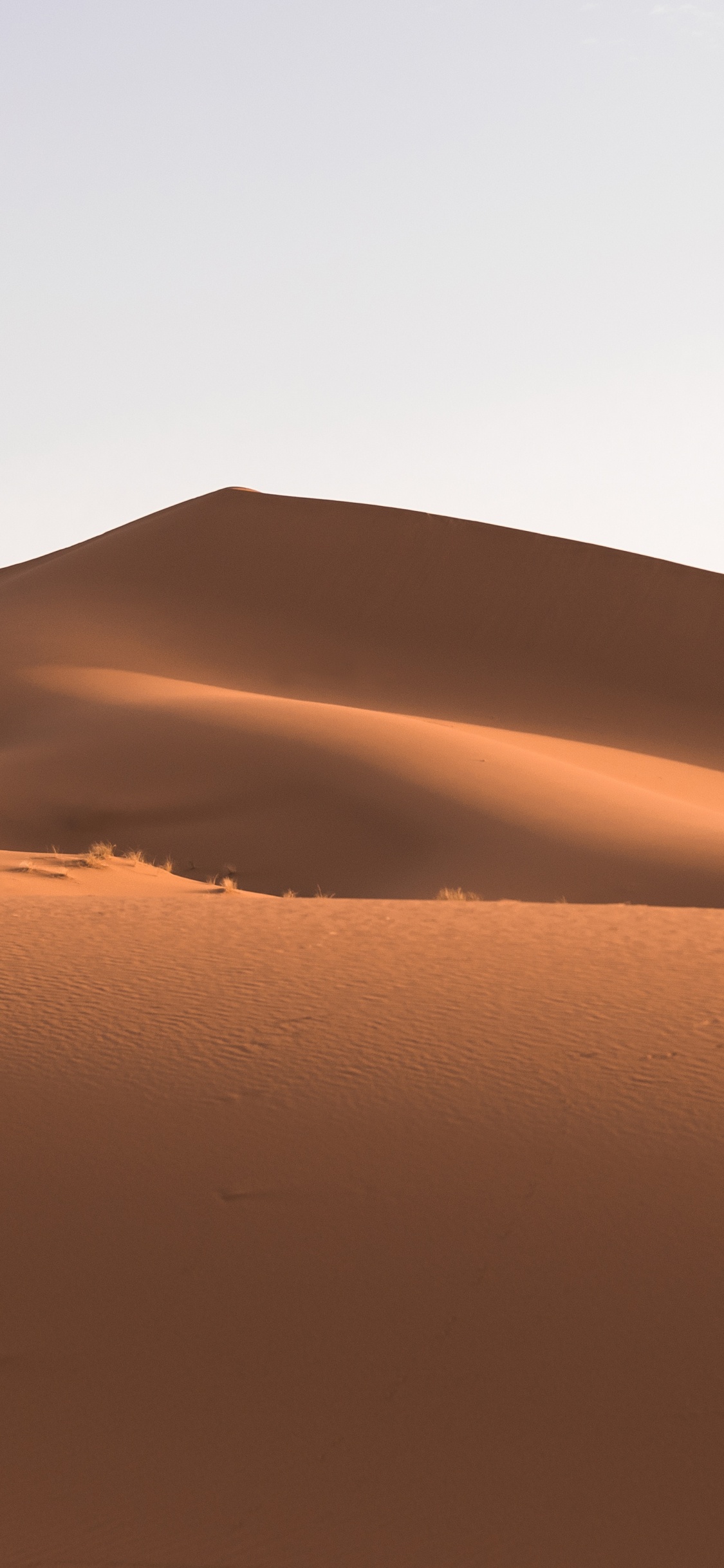 Desert Under Blue Sky During Daytime. Wallpaper in 1125x2436 Resolution