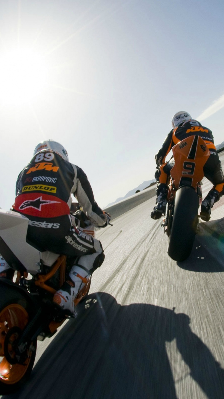 Man in Orange and White Jacket Riding on White and Orange Motocross Dirt Bike. Wallpaper in 750x1334 Resolution