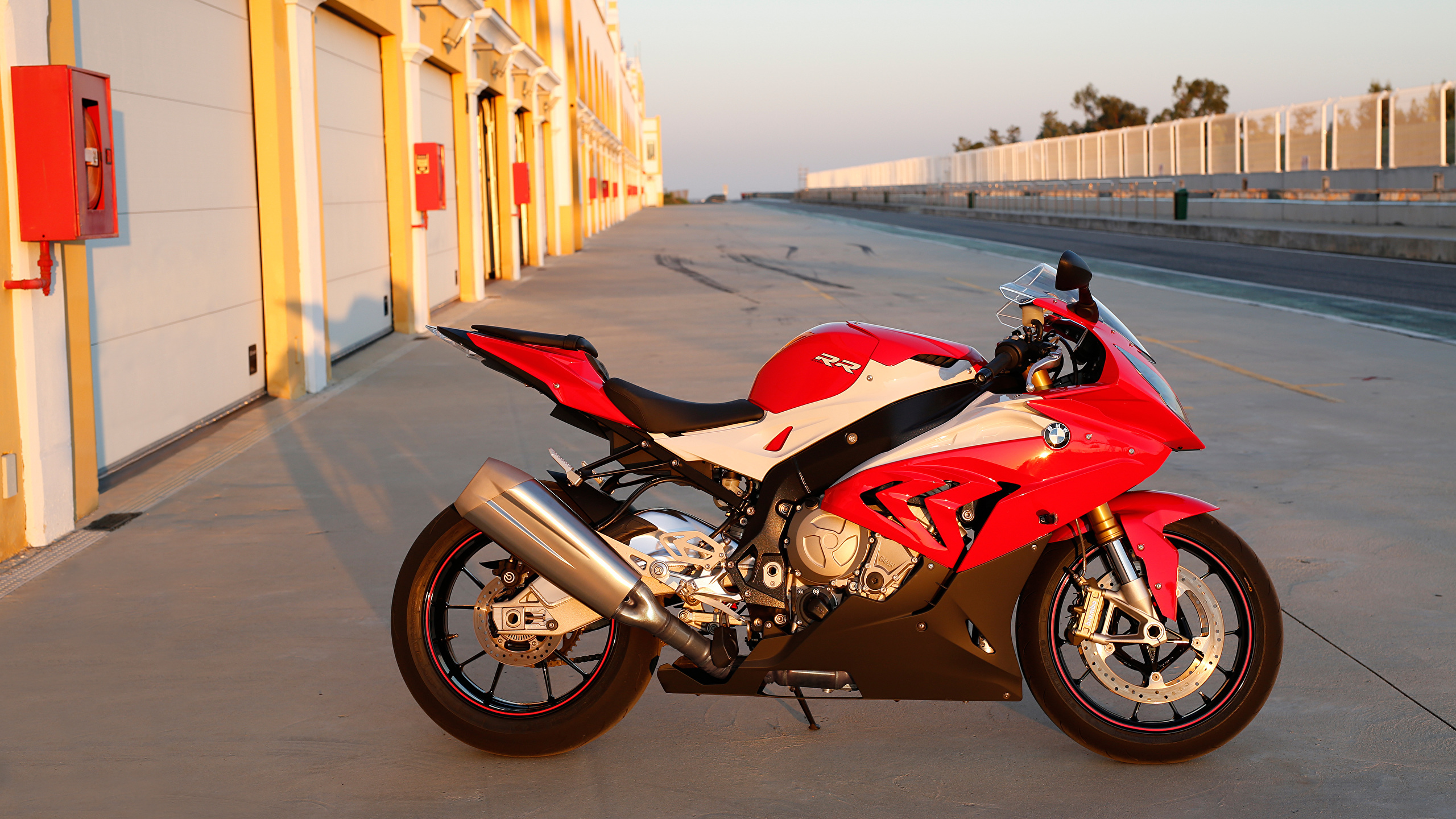 Red and Black Sports Bike Parked on The Side of The Road During Daytime. Wallpaper in 2560x1440 Resolution