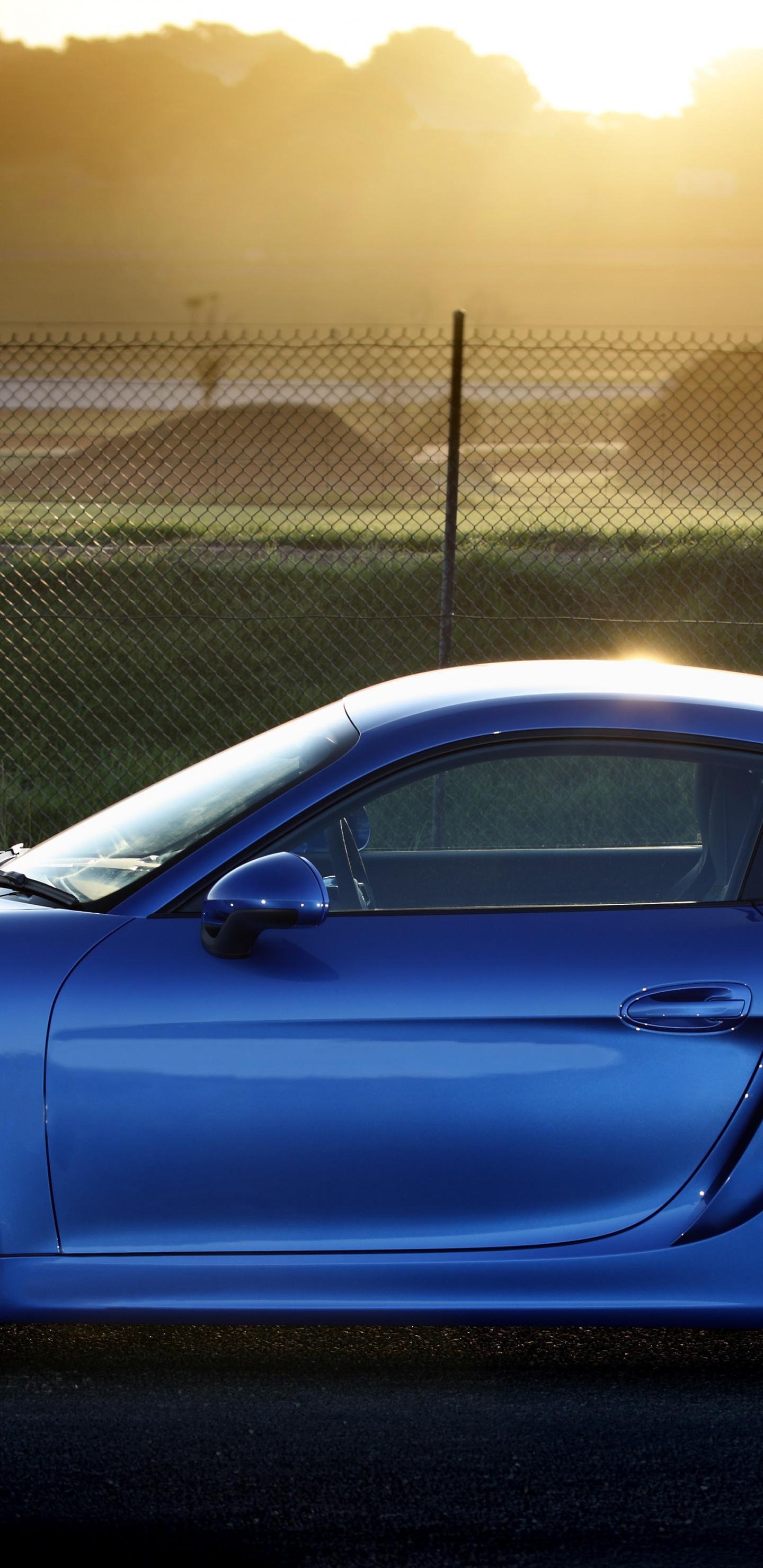 Blue Porsche 911 Parked Near Gray Metal Fence During Daytime. Wallpaper in 1440x2960 Resolution
