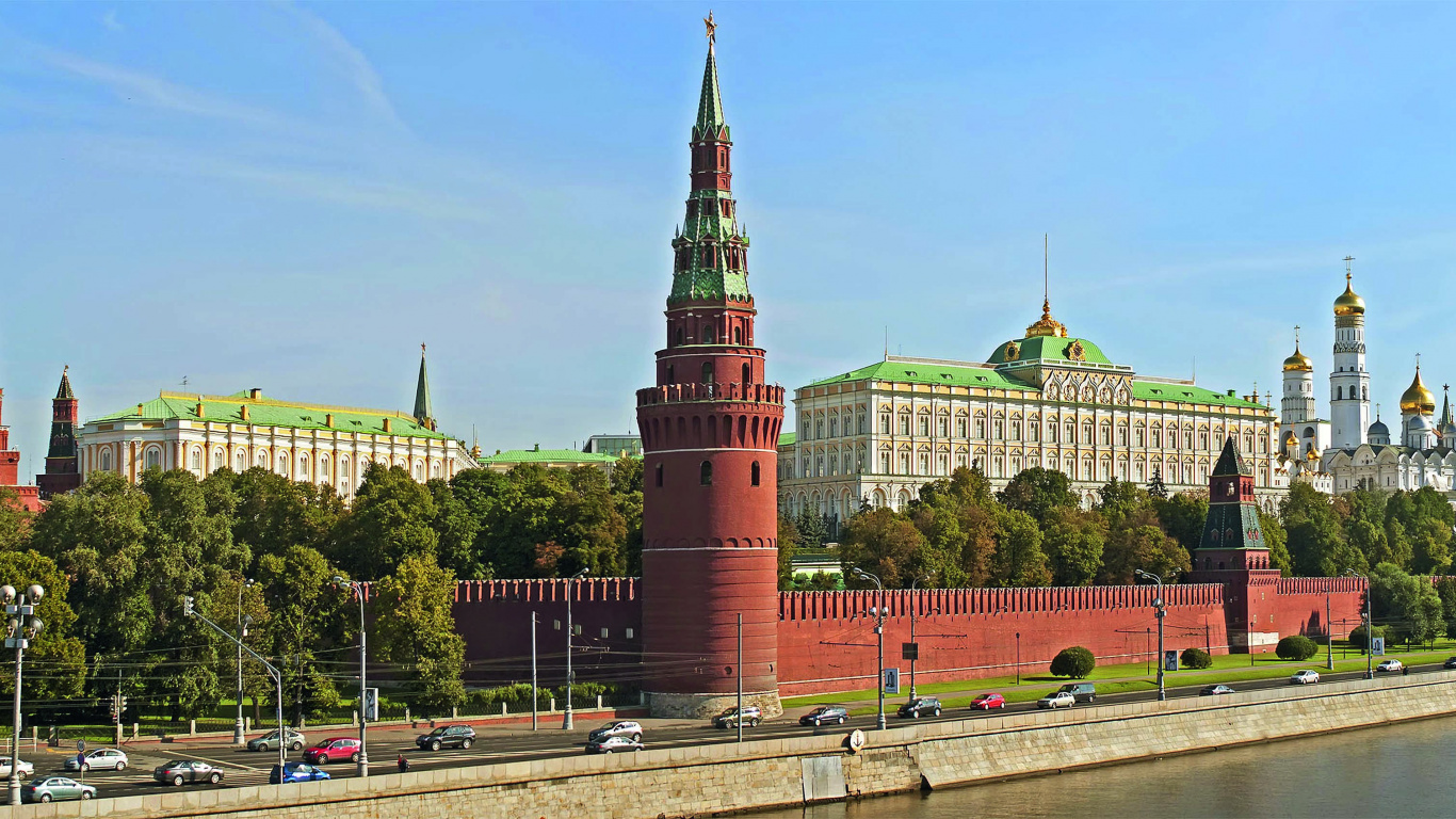 Red and White Concrete Building Near Body of Water During Daytime. Wallpaper in 1366x768 Resolution