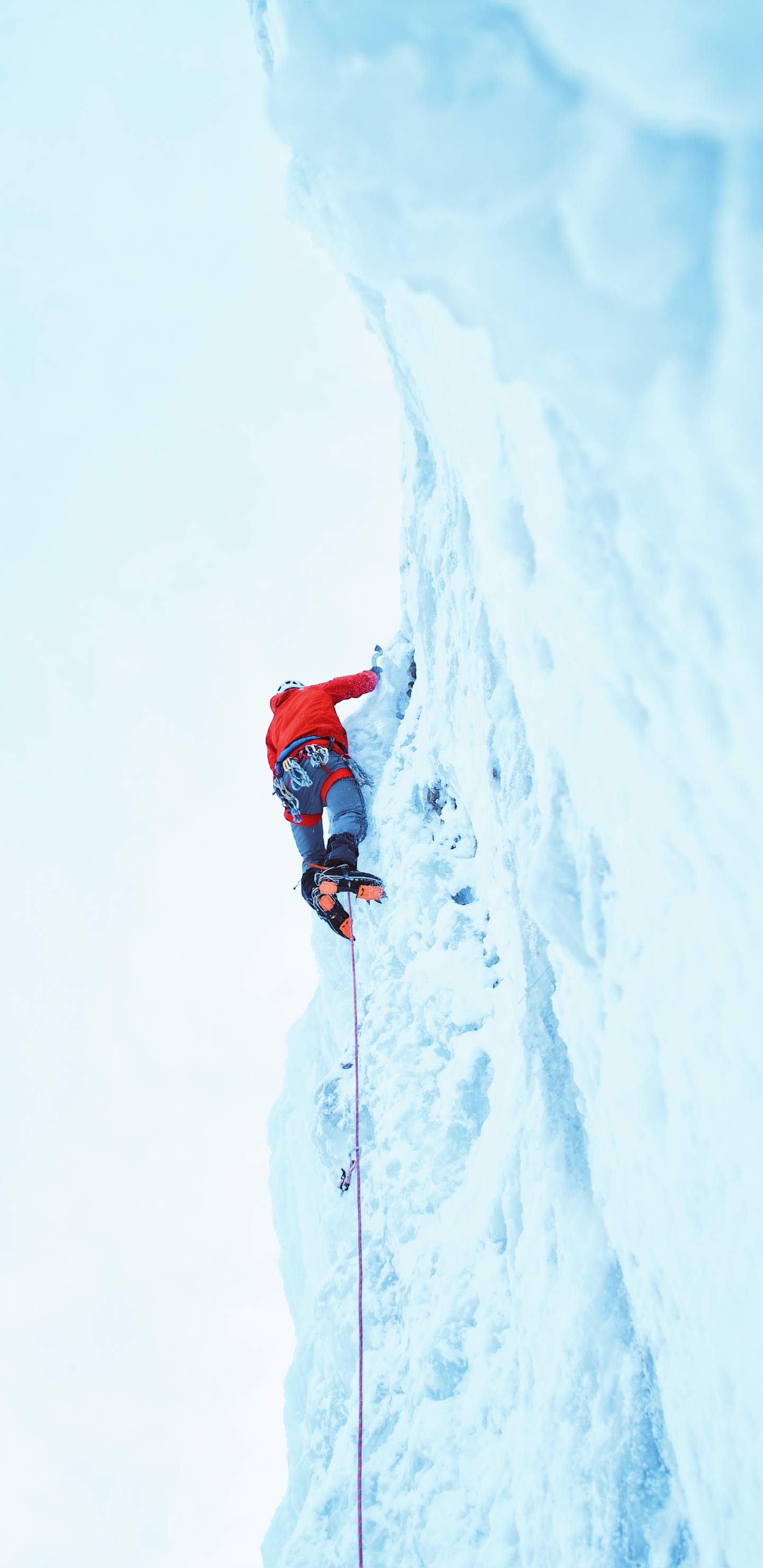 Person in Roter Jacke Und Blauer Hose Auf Schneebedeckten Bergen Tagsüber. Wallpaper in 1440x2960 Resolution