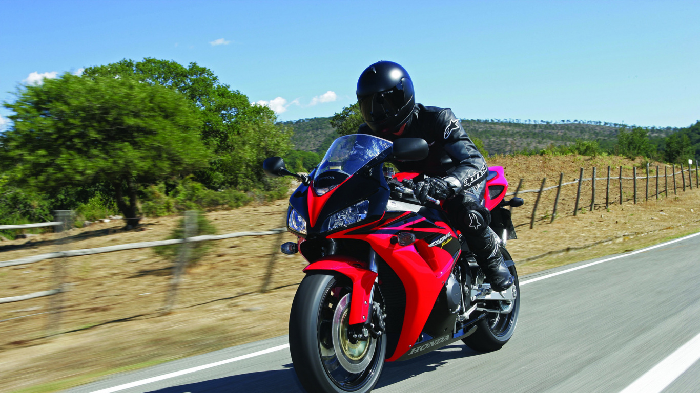 Man in Black and Red Motorcycle Suit Riding on Red Sports Bike on Road During Daytime. Wallpaper in 1366x768 Resolution