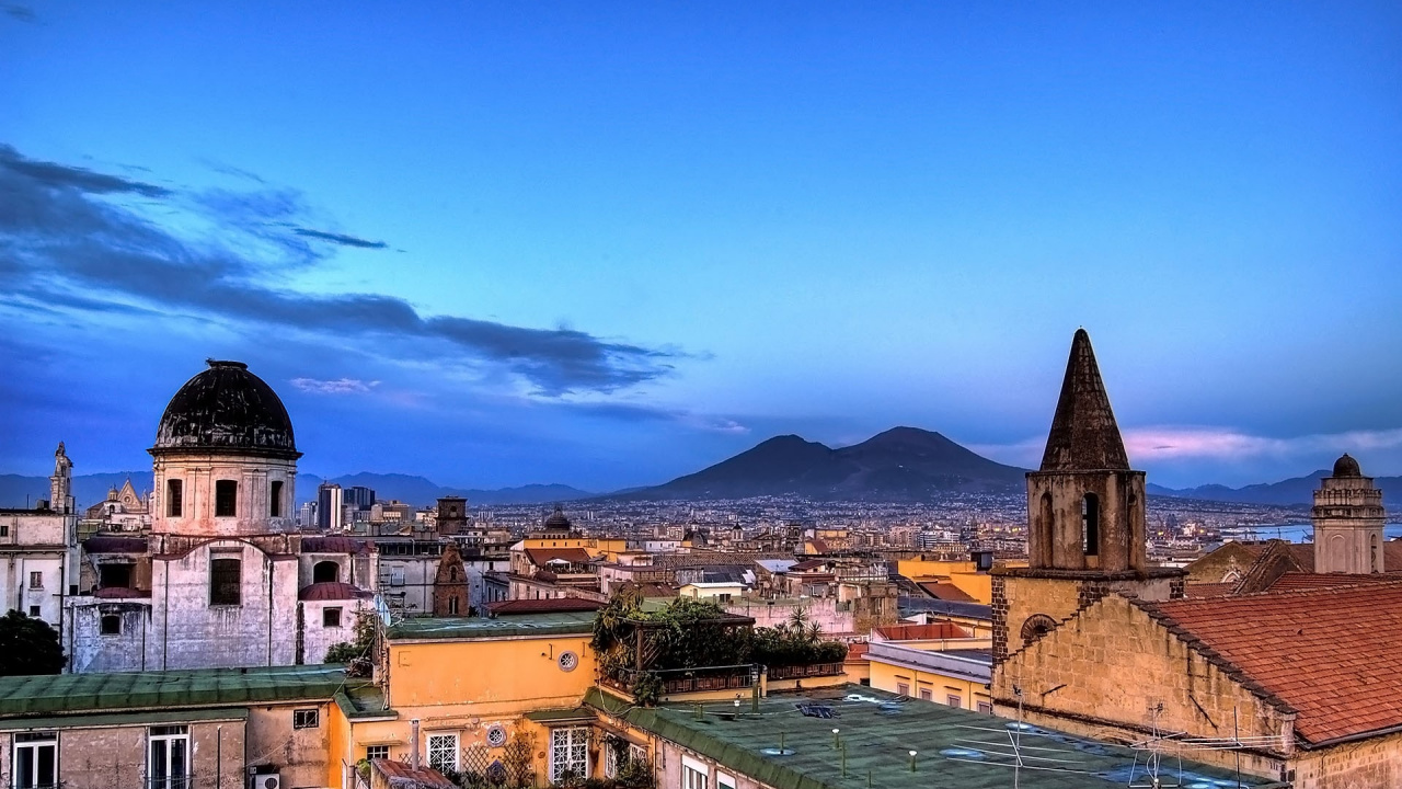 Brown and White Concrete Building Near Body of Water Under Blue Sky During Daytime. Wallpaper in 1280x720 Resolution