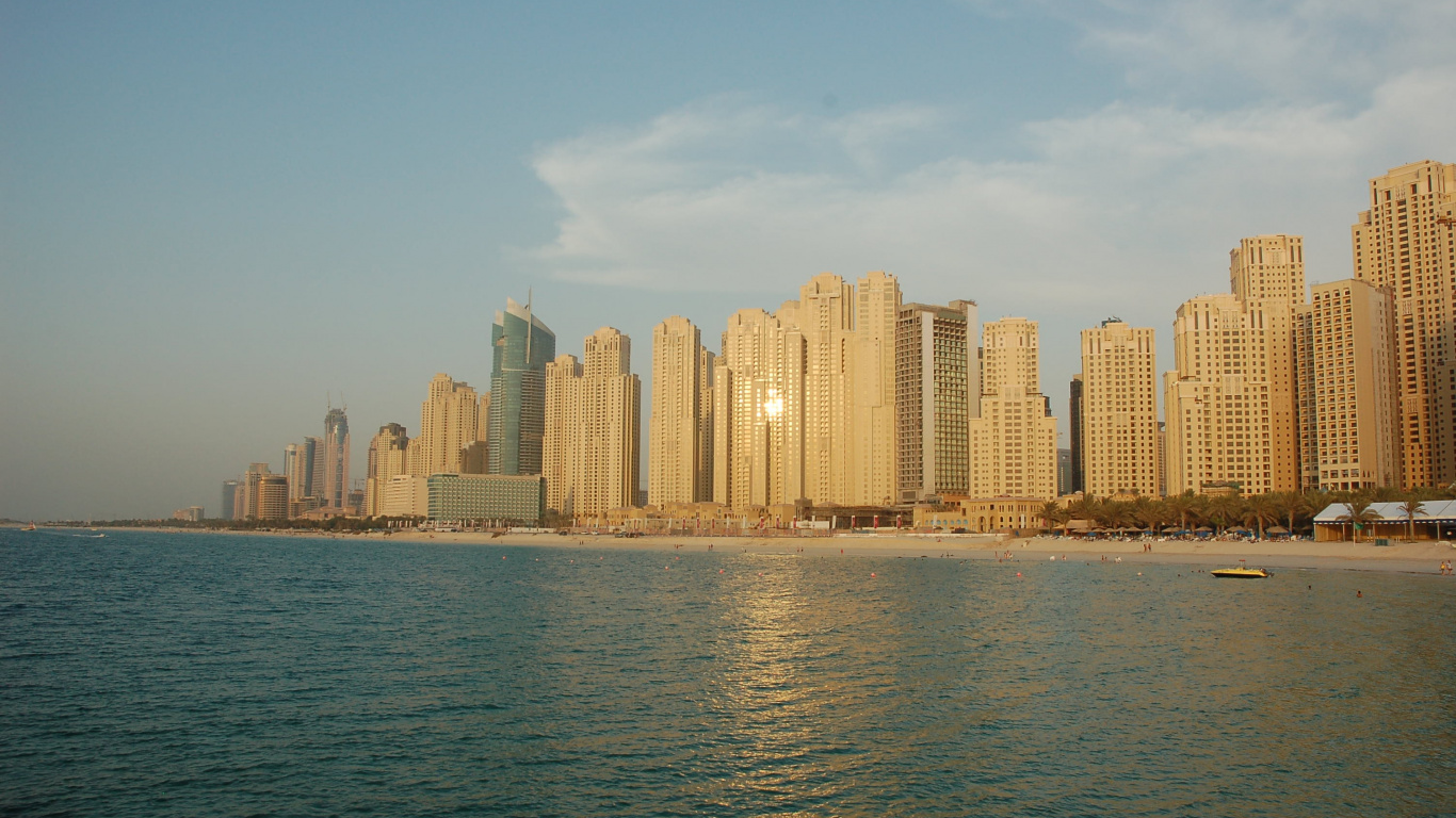 City Skyline Across Body of Water During Daytime. Wallpaper in 1366x768 Resolution