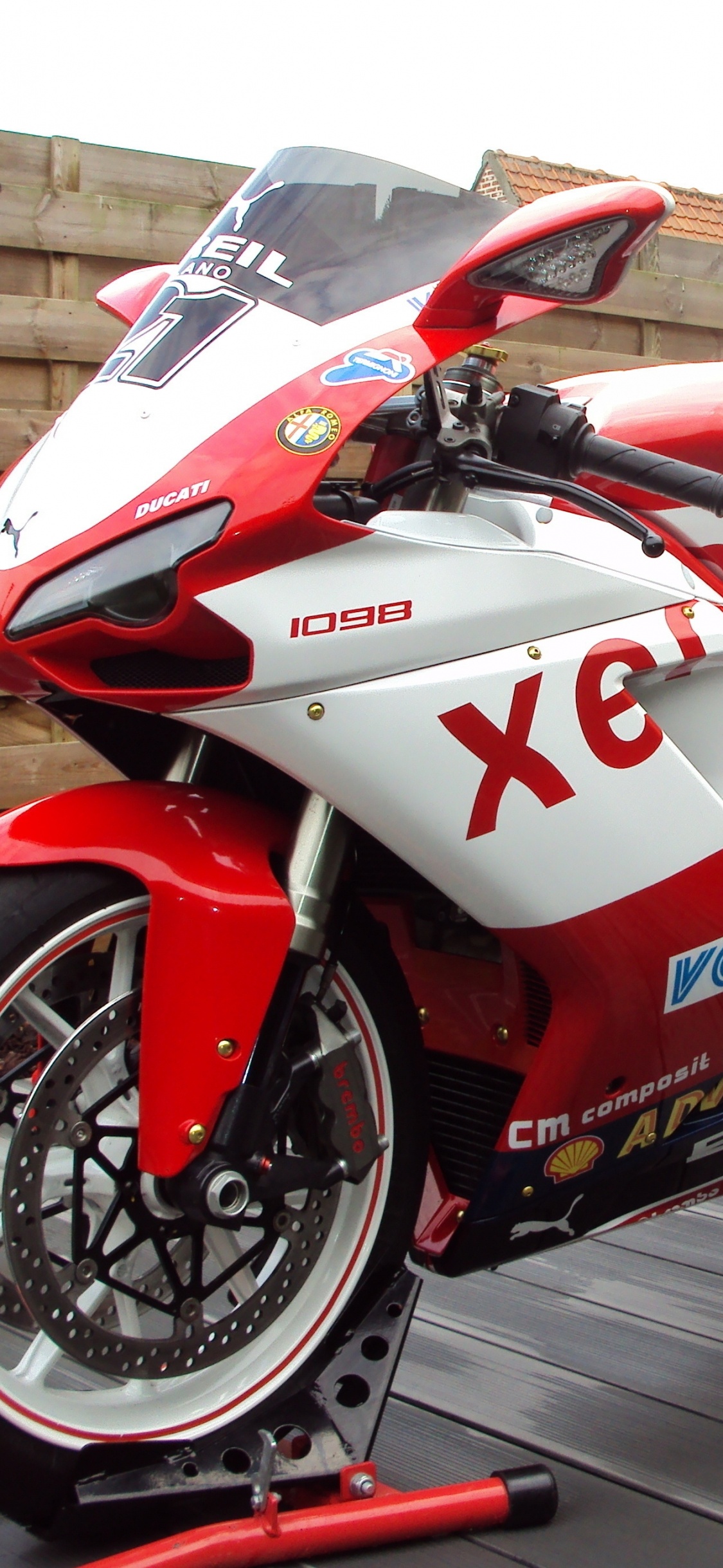Red and White Honda Sports Bike. Wallpaper in 1125x2436 Resolution