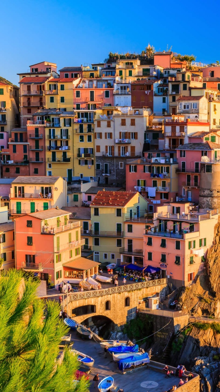 Brown and White Concrete Buildings Near Body of Water During Daytime. Wallpaper in 720x1280 Resolution