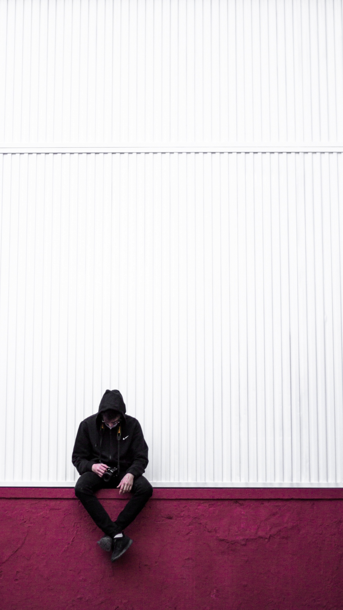 Man in Black Jacket Sitting on Red Carpet. Wallpaper in 1440x2560 Resolution