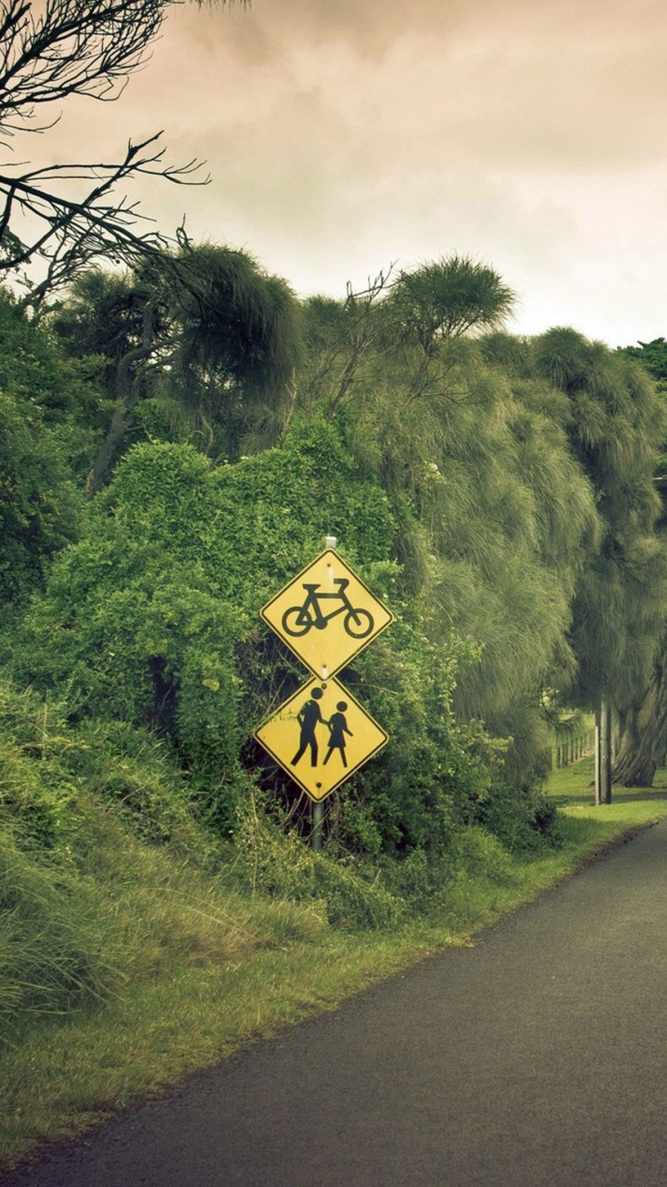 Panneau de Signalisation Jaune et Noir Près de la Montagne Verte Sous Des Nuages Blancs Pendant la Journée. Wallpaper in 750x1334 Resolution