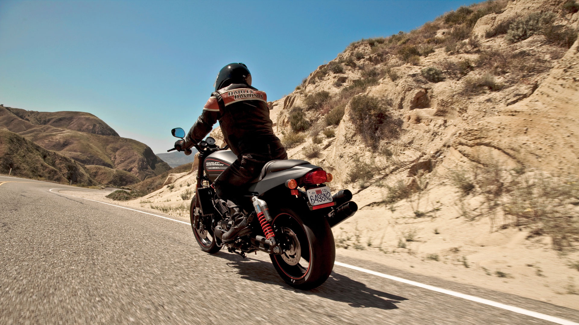 Man Riding on Black and Red Sports Bike on Gray Asphalt Road During Daytime. Wallpaper in 1920x1080 Resolution
