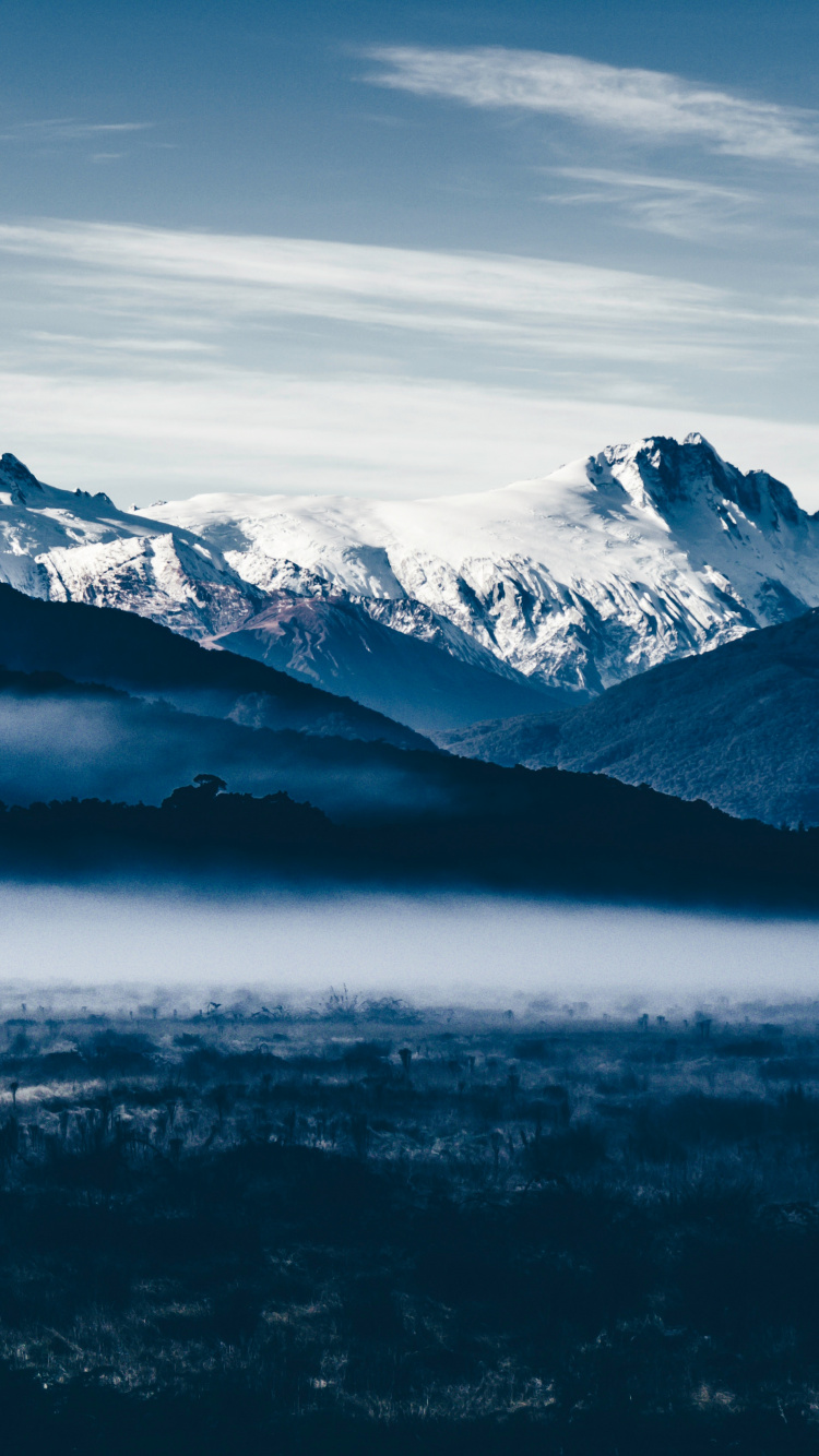 Schneebedeckte Berge Unter Bewölktem Himmel Tagsüber. Wallpaper in 750x1334 Resolution