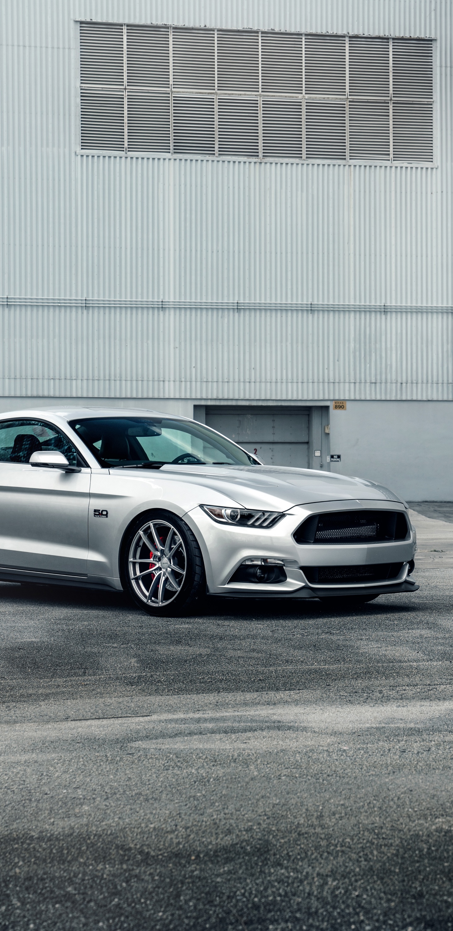 White Sedan Parked Near White Building. Wallpaper in 1440x2960 Resolution