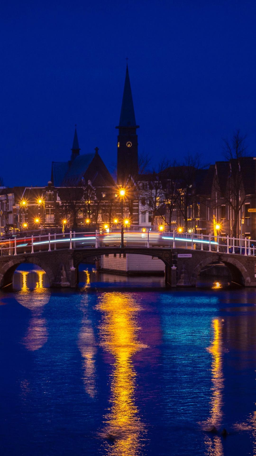 Body of Water Near Building During Night Time. Wallpaper in 1080x1920 Resolution