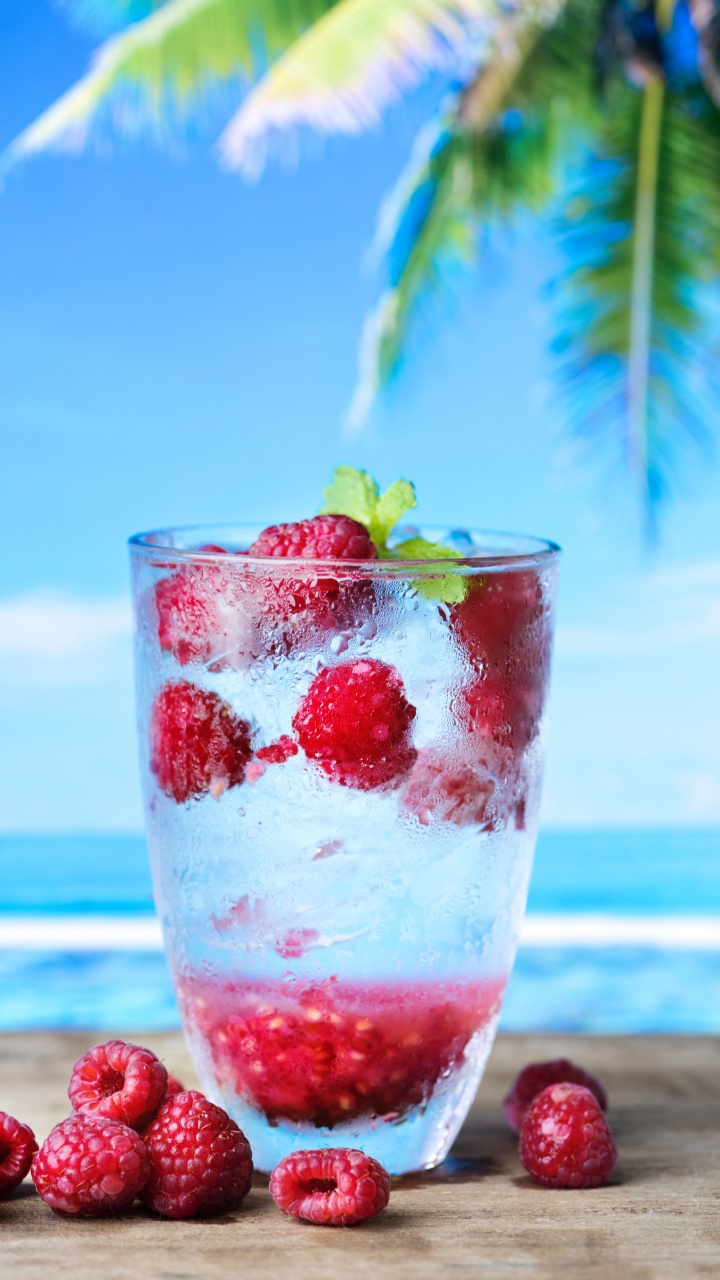 Clear Drinking Glass With Strawberry and Ice. Wallpaper in 720x1280 Resolution