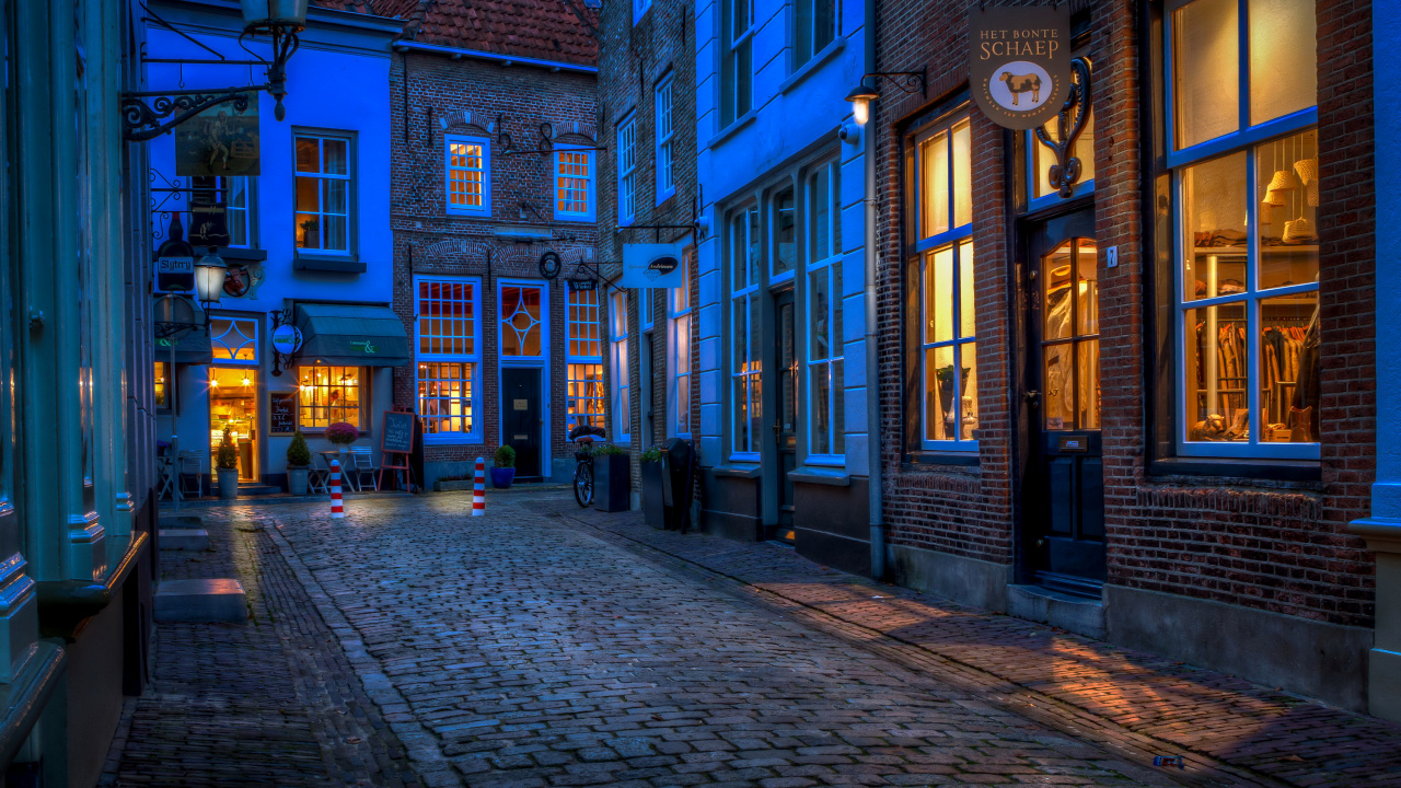 Brown Brick Building With Lights Turned on During Night Time. Wallpaper in 1280x720 Resolution