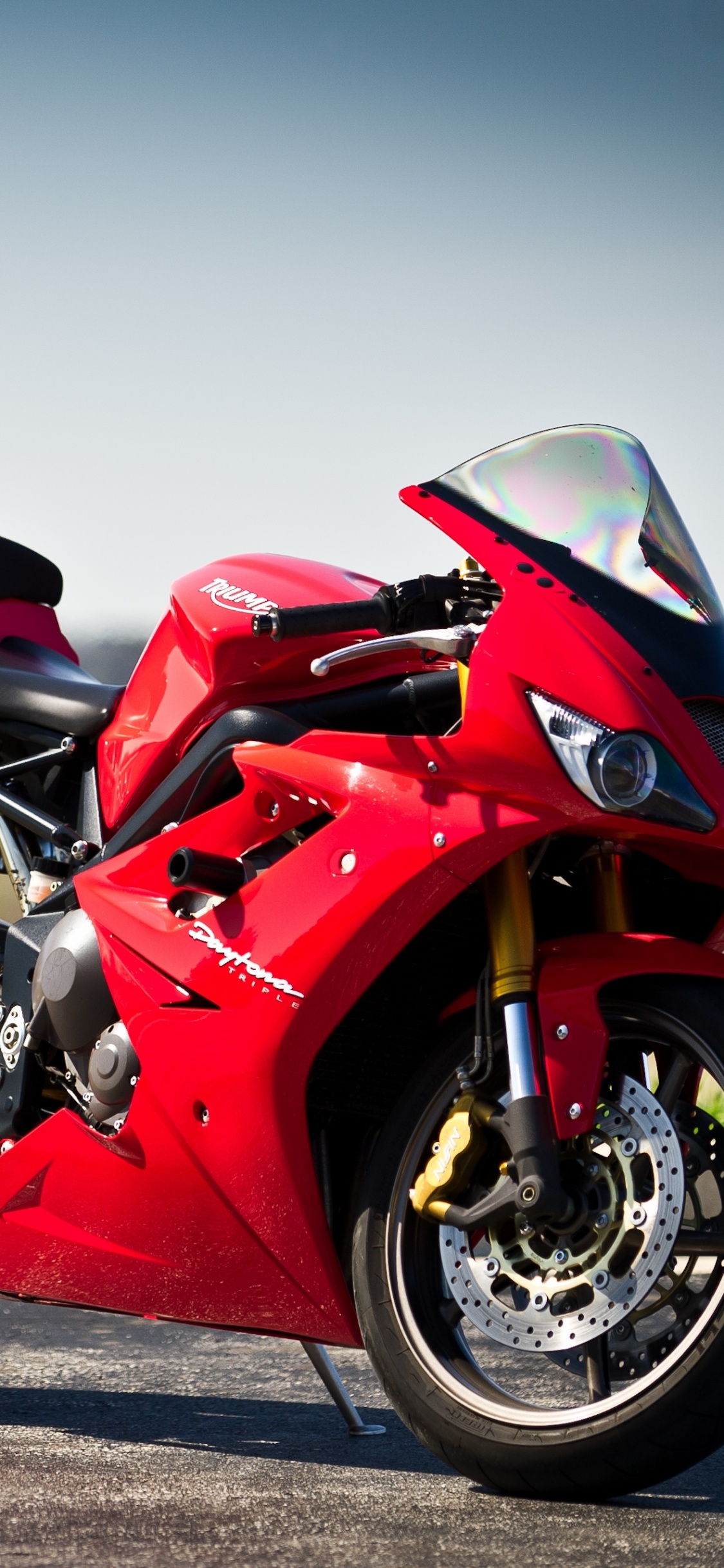 Red and Black Sports Bike on Road During Daytime. Wallpaper in 1125x2436 Resolution