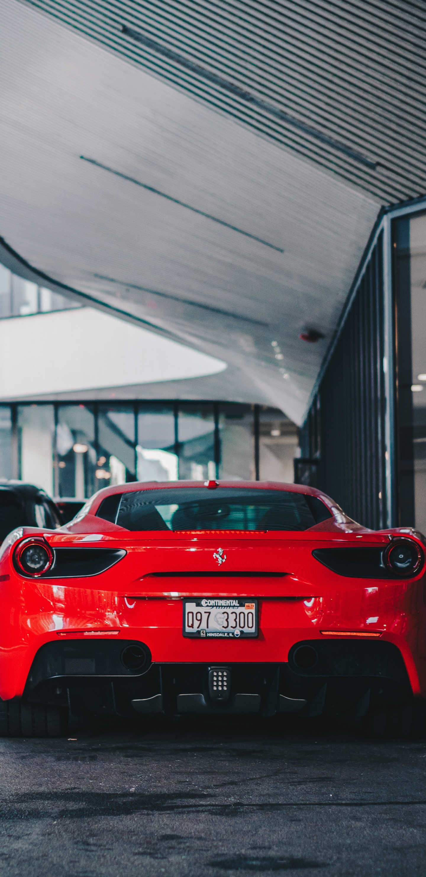 Red Ferrari Car Parked Near Building. Wallpaper in 1440x2960 Resolution