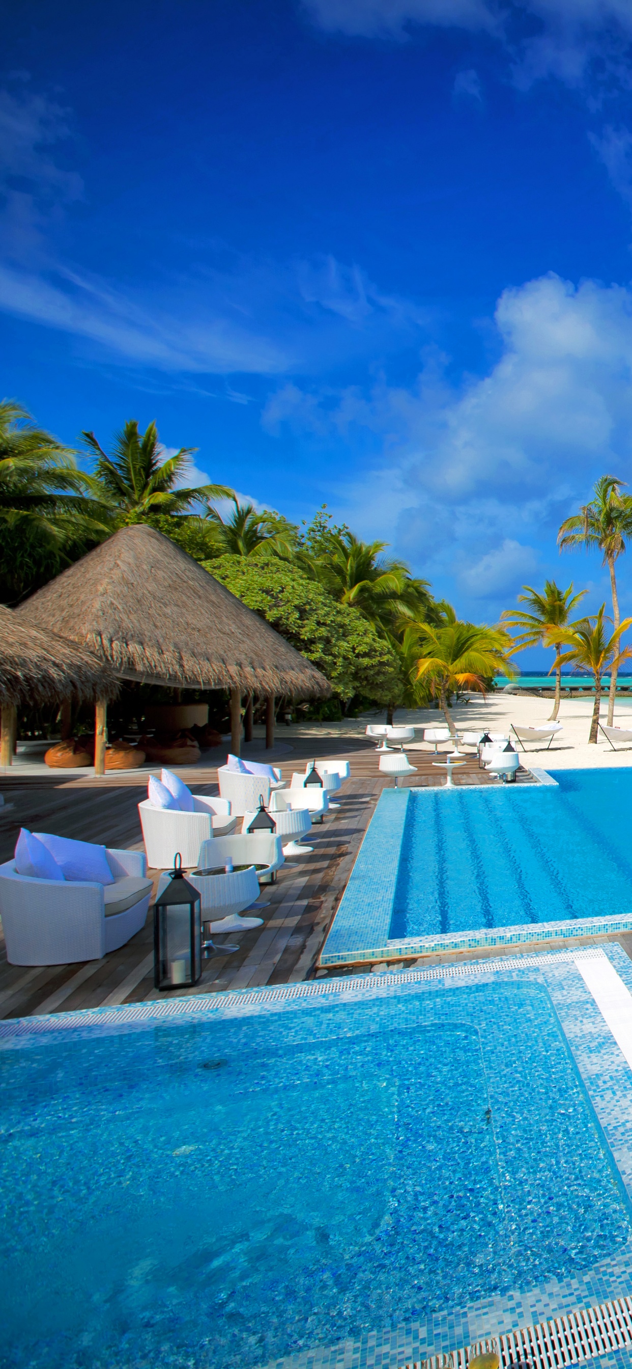 Brown Wooden Lounge Chairs on Blue Swimming Pool During Daytime. Wallpaper in 1242x2688 Resolution