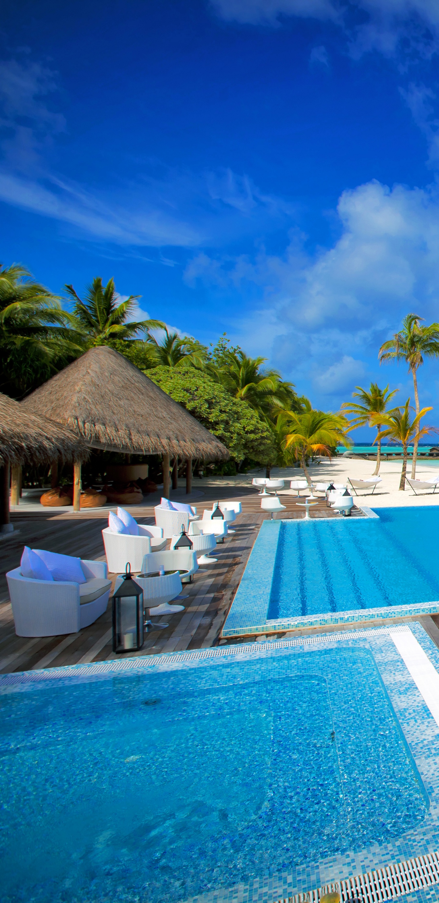 Brown Wooden Lounge Chairs on Blue Swimming Pool During Daytime. Wallpaper in 1440x2960 Resolution