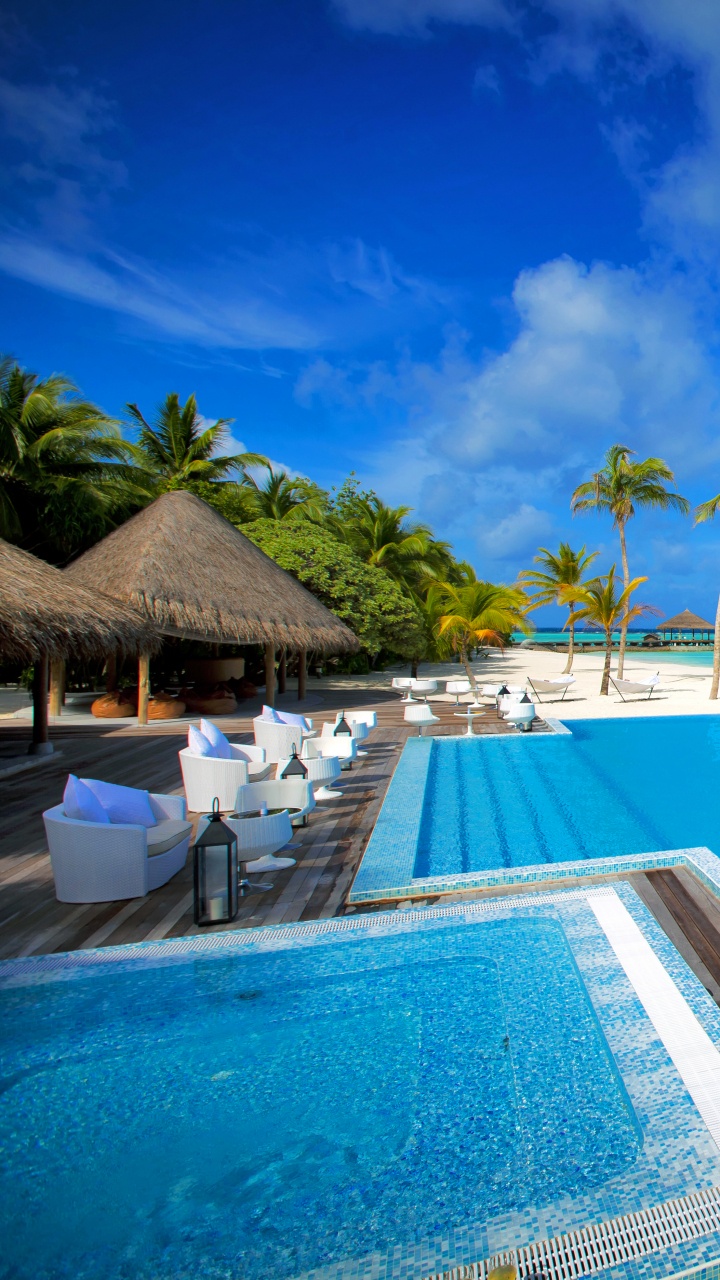 Brown Wooden Lounge Chairs on Blue Swimming Pool During Daytime. Wallpaper in 720x1280 Resolution