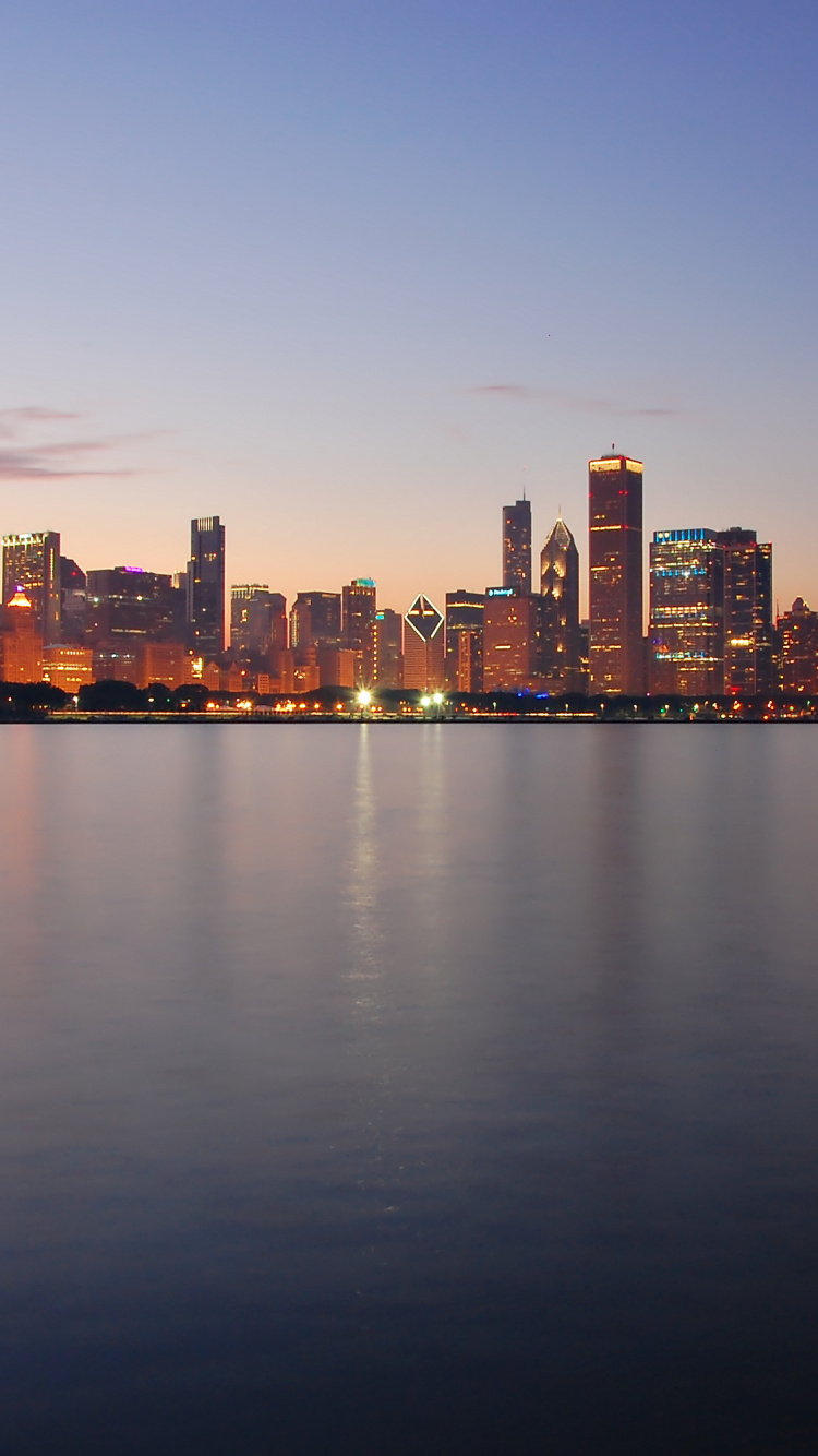 City Skyline Across Body of Water During Night Time. Wallpaper in 750x1334 Resolution