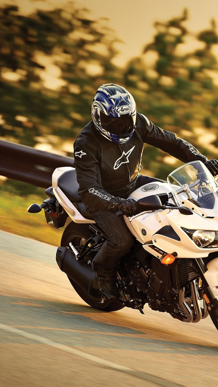 Man in Black and White Motorcycle Suit Riding White Sports Bike. Wallpaper in 720x1280 Resolution
