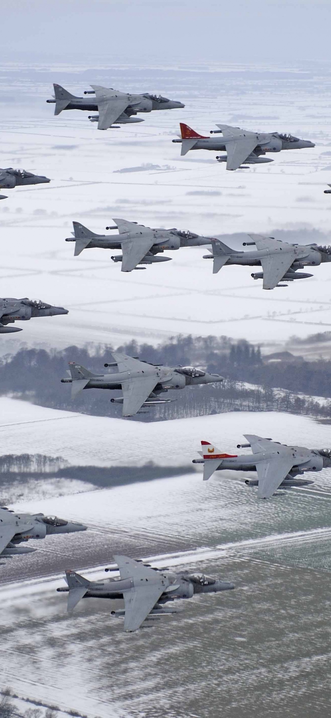 Weißes Und Rotes Düsenflugzeug Auf Schneebedecktem Boden Tagsüber. Wallpaper in 1125x2436 Resolution