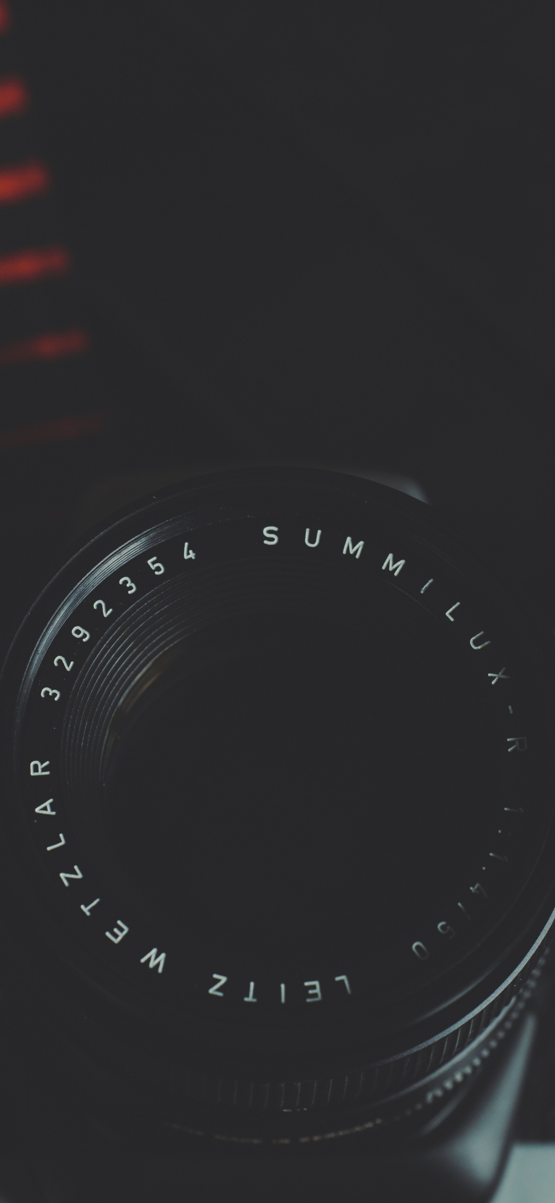Black Camera Lens on Red and White Striped Textile. Wallpaper in 1125x2436 Resolution
