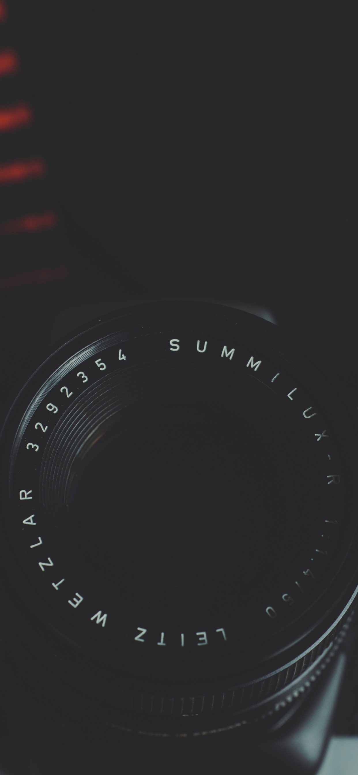 Black Camera Lens on Red and White Striped Textile. Wallpaper in 1242x2688 Resolution