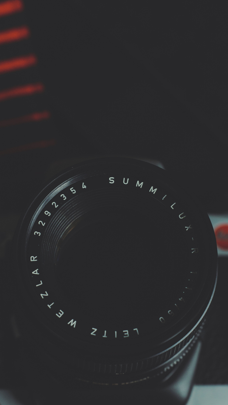 Black Camera Lens on Red and White Striped Textile. Wallpaper in 750x1334 Resolution