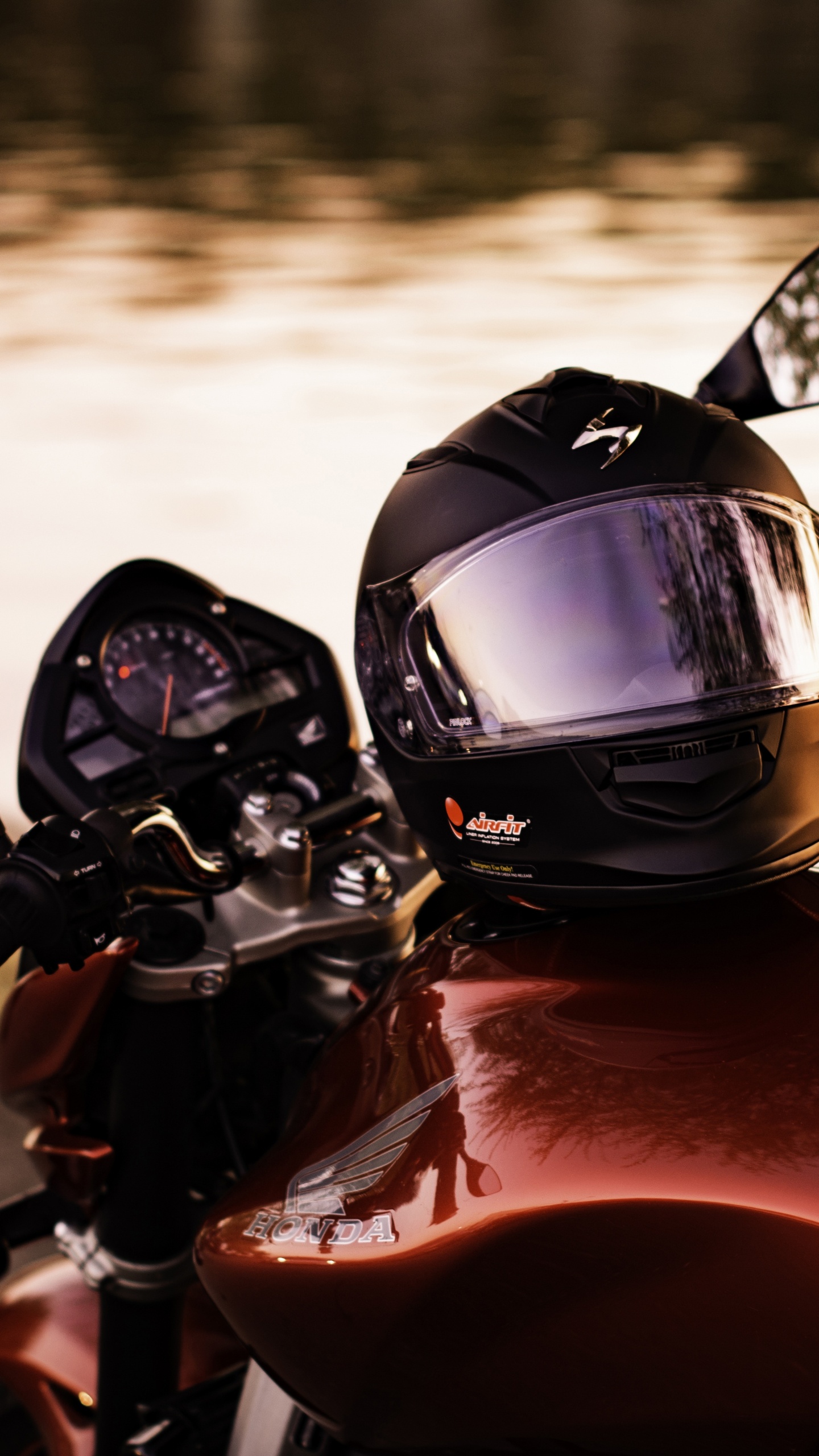 Black and Red Motorcycle Helmet on Red Motorcycle. Wallpaper in 1440x2560 Resolution