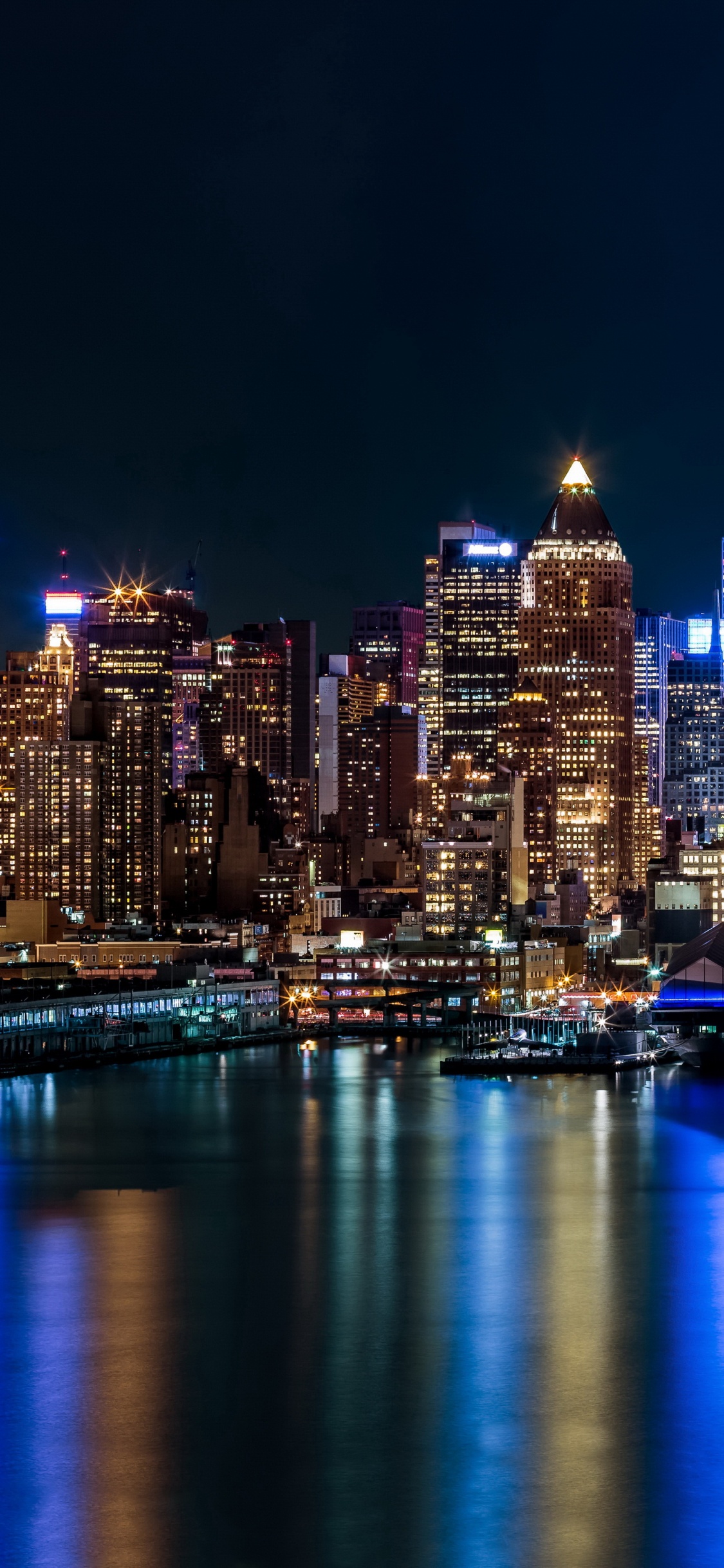 City Skyline During Night Time. Wallpaper in 1125x2436 Resolution