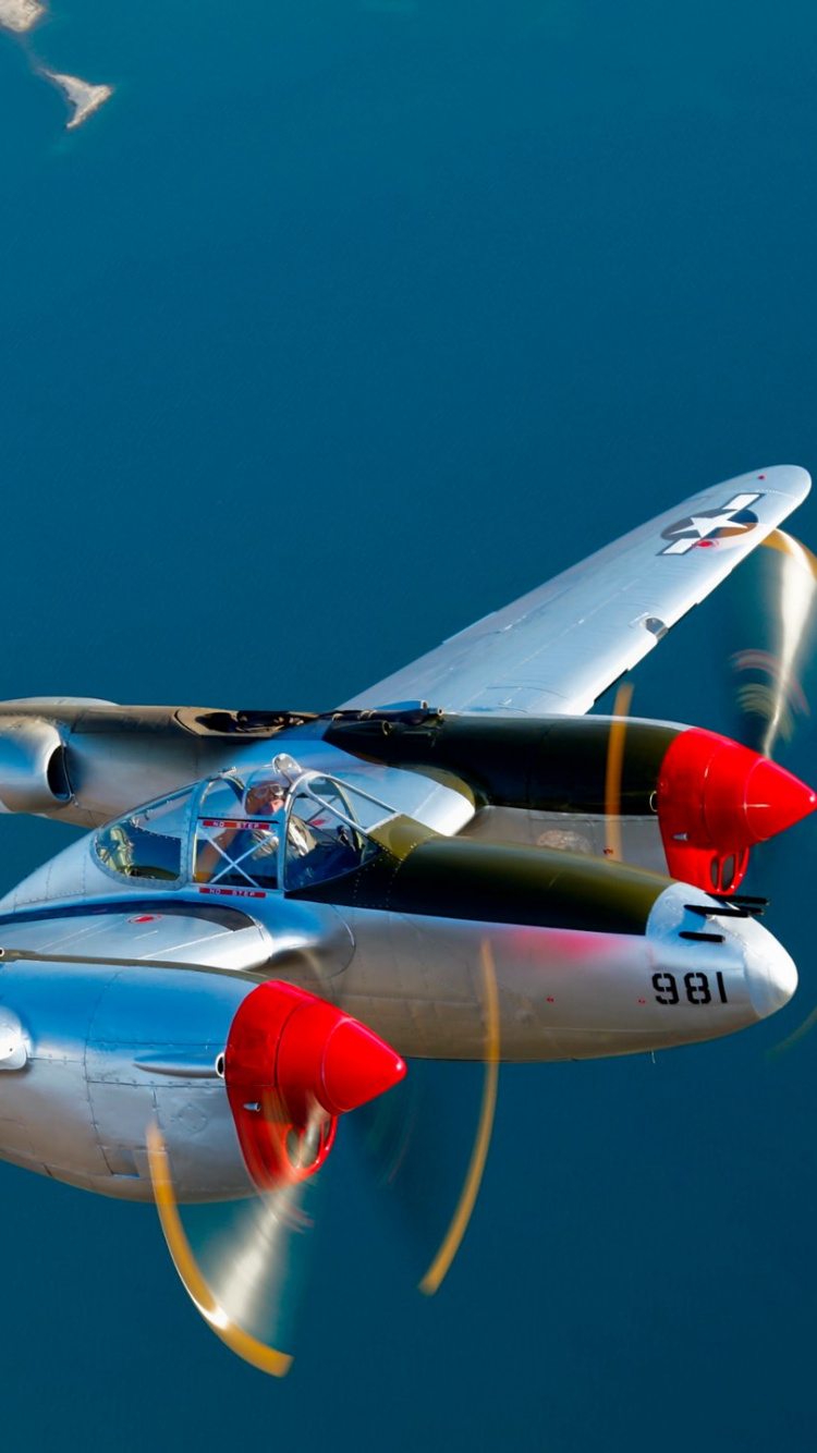 Avión Blanco y Rojo Volando Durante el Día. Wallpaper in 750x1334 Resolution