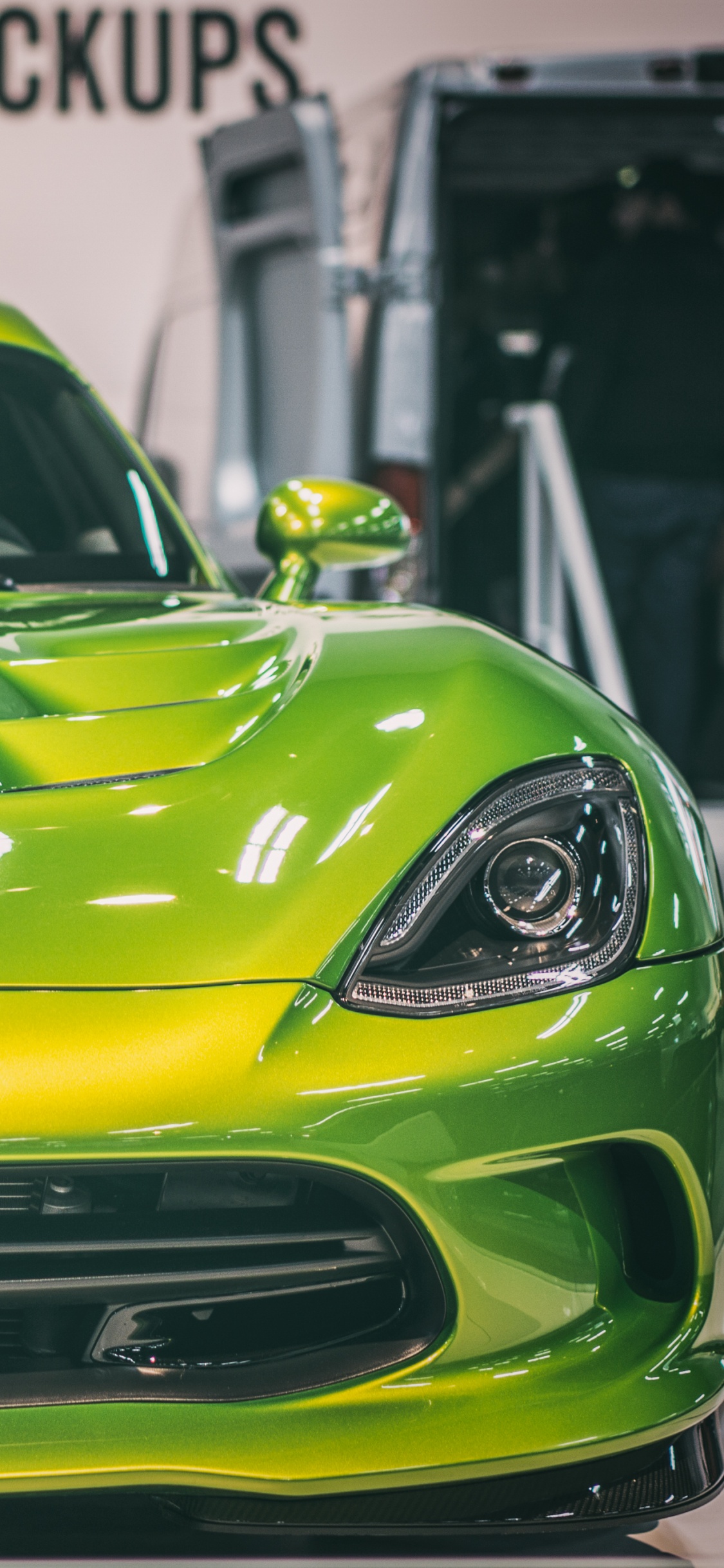 Yellow Porsche 911 Parked in a Parking Lot. Wallpaper in 1125x2436 Resolution