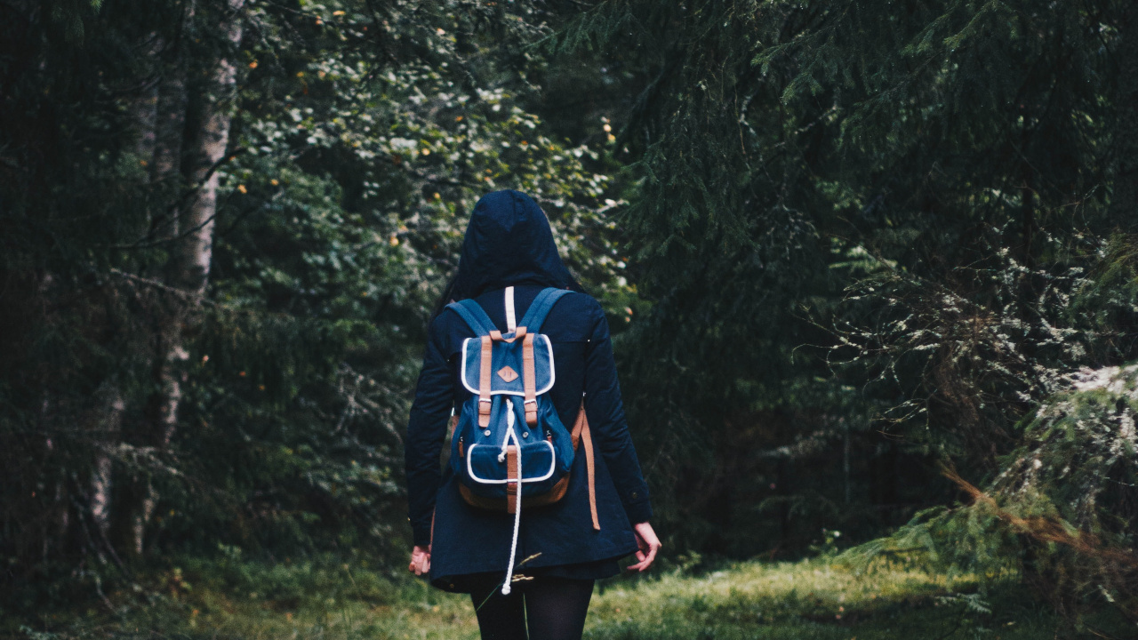 Woman in Black and Red Jacket Standing on Green Grass Field. Wallpaper in 1280x720 Resolution