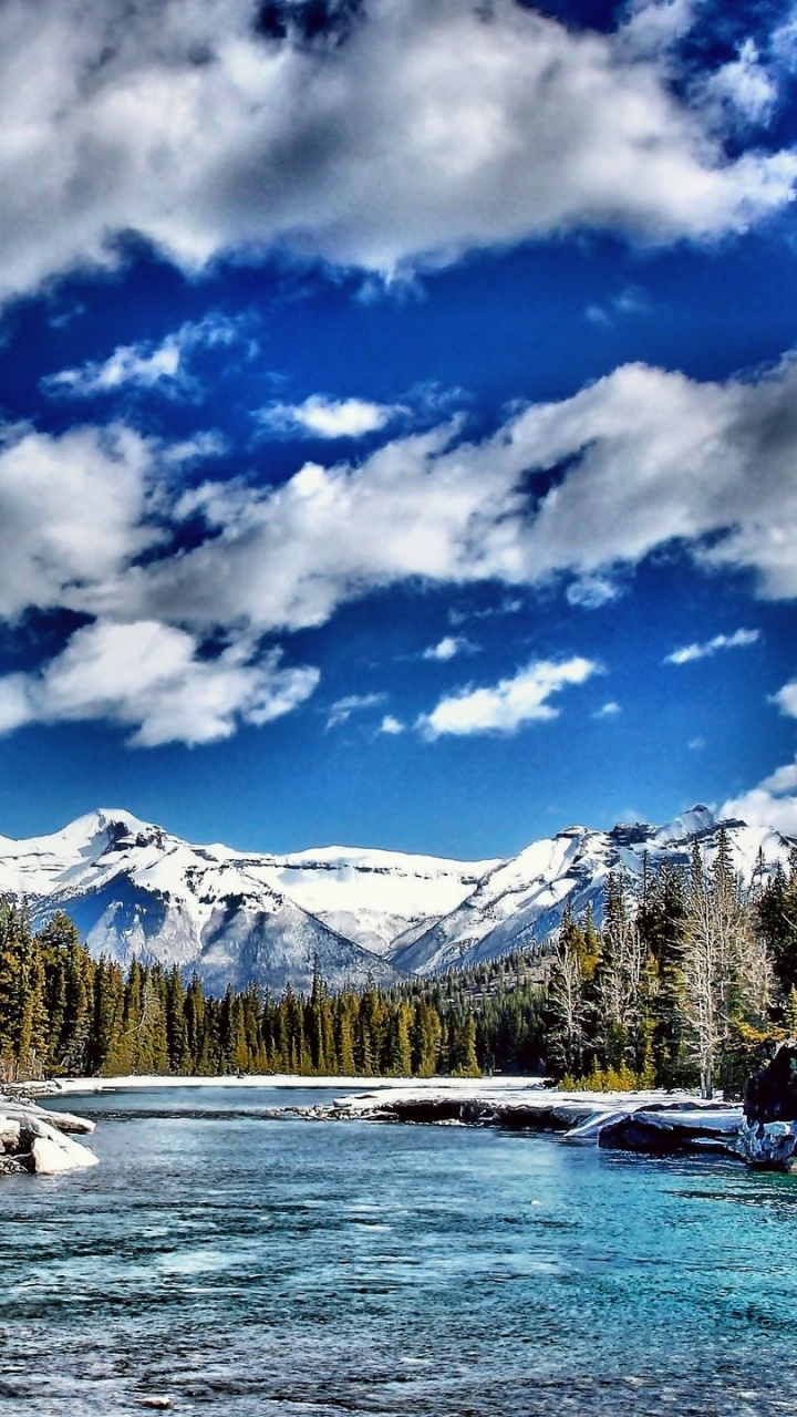 Green Trees Near Snow Covered Mountain Under Blue and White Cloudy Sky During Daytime. Wallpaper in 720x1280 Resolution
