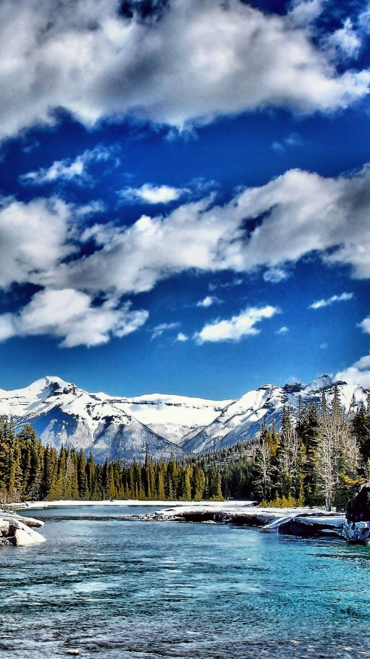Green Trees Near Snow Covered Mountain Under Blue and White Cloudy Sky During Daytime. Wallpaper in 750x1334 Resolution